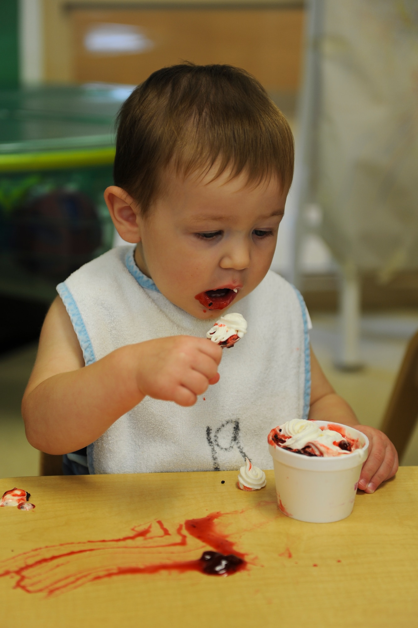 Callum Kirchoff, son of U.S. Air Force Capts. Meredith and Aaron Kirchoff, eats ice cream during an ice cream social at Moody Air Force Base, Ga., July 25, 2014. The Child Development Center II hosted the ice cream social to celebrate National Ice Cream Month. (U.S. Air Force photo by Airman 1st class Alexis Millican/Released)