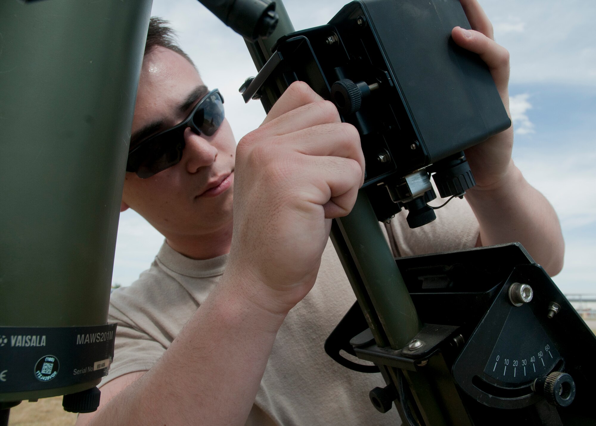 Senior Airman Nelson, 90th Operations Support Squadron, practices setting up the tactical meteorological equipment outside of the 37th Helicopter Squadron July 24, 2014. The TMQ is used primarily in a deployed environment or as a backup when base weather equipment fails. (U.S. Air Force photo by Airman Malcolm Mayfield)