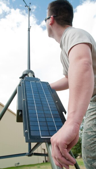 Senior Airman Nelson, 90th Operations Support Squadron, practices setting up the tactical meteorological equipment outside of the 37th Helicopter Squadron July 24, 2014. The TMQ is used primarily in a deployed environment or as a backup when base weather equipment fails. (U.S. Air Force photo by Airman Malcolm Mayfield)