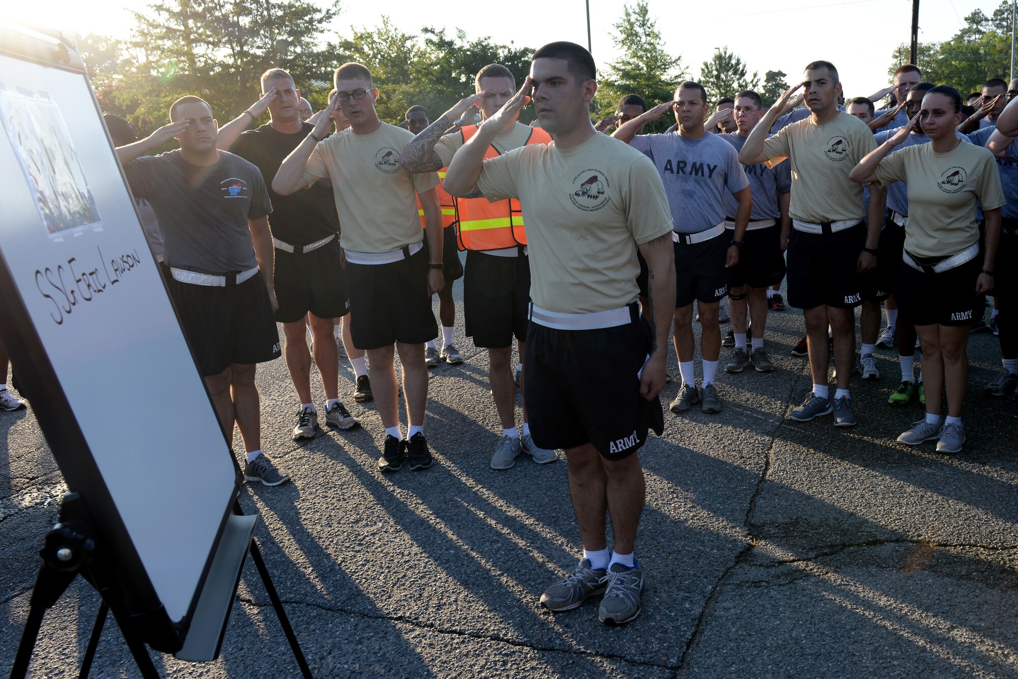 U.S. Army Soldiers from the 359th Inland Cargo Transfer Company, 10th Transportation Battalion, 7th Transportation Brigade (Expeditionary), salute in honor of a fallen Soldier at Fort Eustis, Va., July 25, 2014. Runners ran a memorial 5K in honor of three fallen comrades from the 359th ICTC; Staff Sgt. Justin Johnson of Hobe Sound, Florida; Sgt. Eric Lawson of Stockbridge, Georgia; and Sgt. Caryn Nouv of York County, Virginia who were killed in Bagram, Afghanistan in 2013. (U.S. Air Force photo by Senior Airman Teresa J.C. Aber/Released)