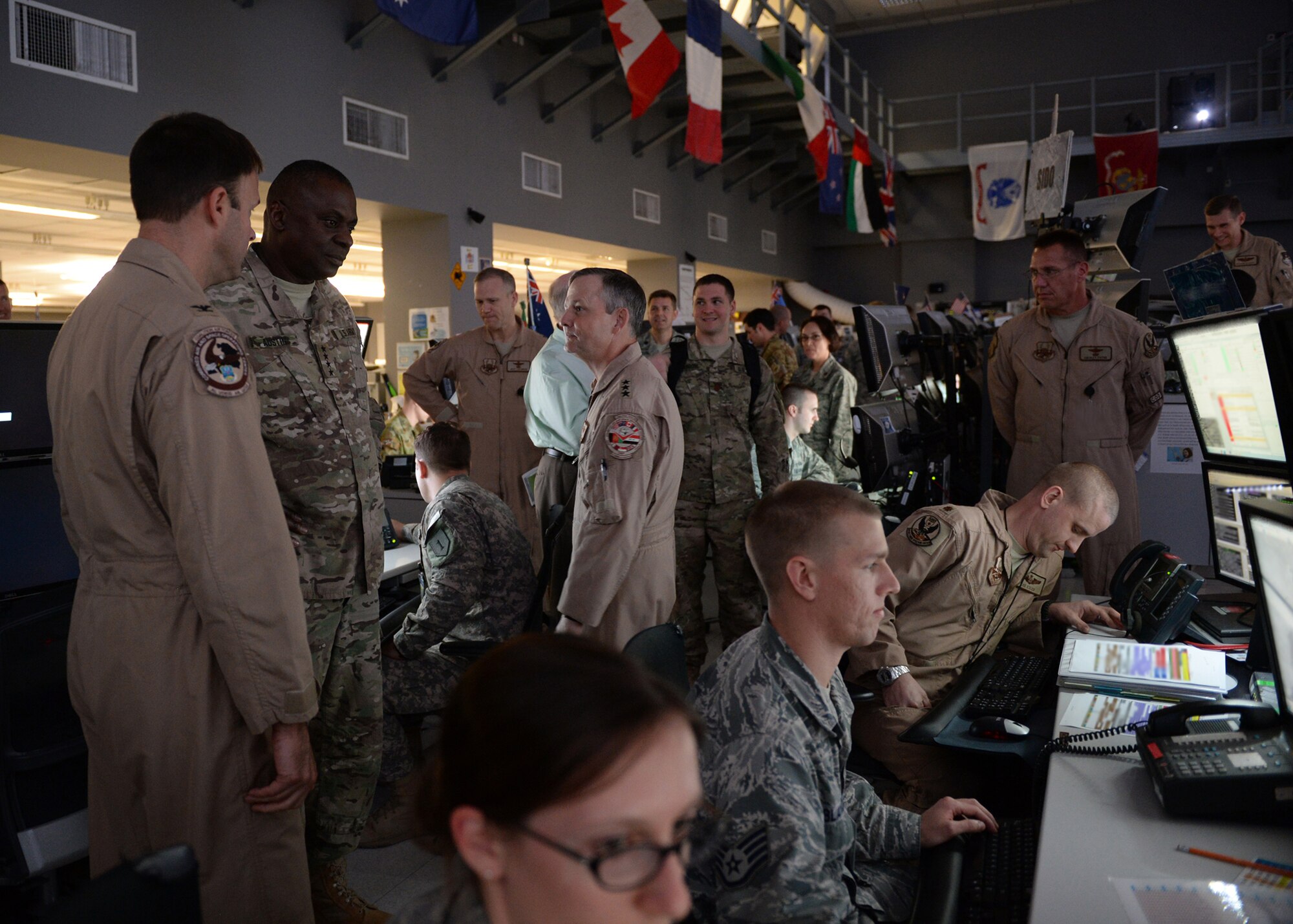 General Lloyd J. Austin III, commander of U.S. Central Command, visits the Combined Air and Space Operations Center floor during an orientation visit, June 28, 2014, Al Udeid Air Base, Qatar. The CAOC provides the command and control of airpower throughout Iraq, Afghanistan and 18 other nations. (U.S. Air Force photo illustration by Staff Sgt. Shawn Nickel)