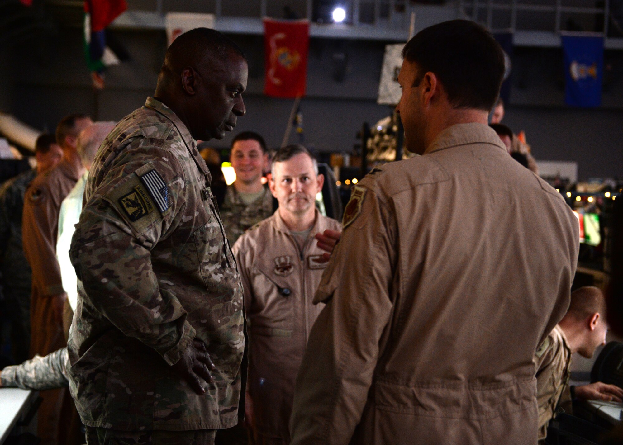 General Lloyd J. Austin III, commander of U.S. Central Command, is briefed on daily protocol at the Combined Air and Space Operations Center by Col. Harvey Newton, commander of the 609th Air Operations Center, and Air Force Lt. Gen. John Hesterman III, commander of U.S. Air Forces Central Command, June 28, 2014, Al Udeid Air Base, Qatar. The CAOC provides the command and control of airpower throughout Iraq, Afghanistan and 18 other nations. (U.S. Air Force photo illustration by Staff Sgt. Shawn Nickel) 