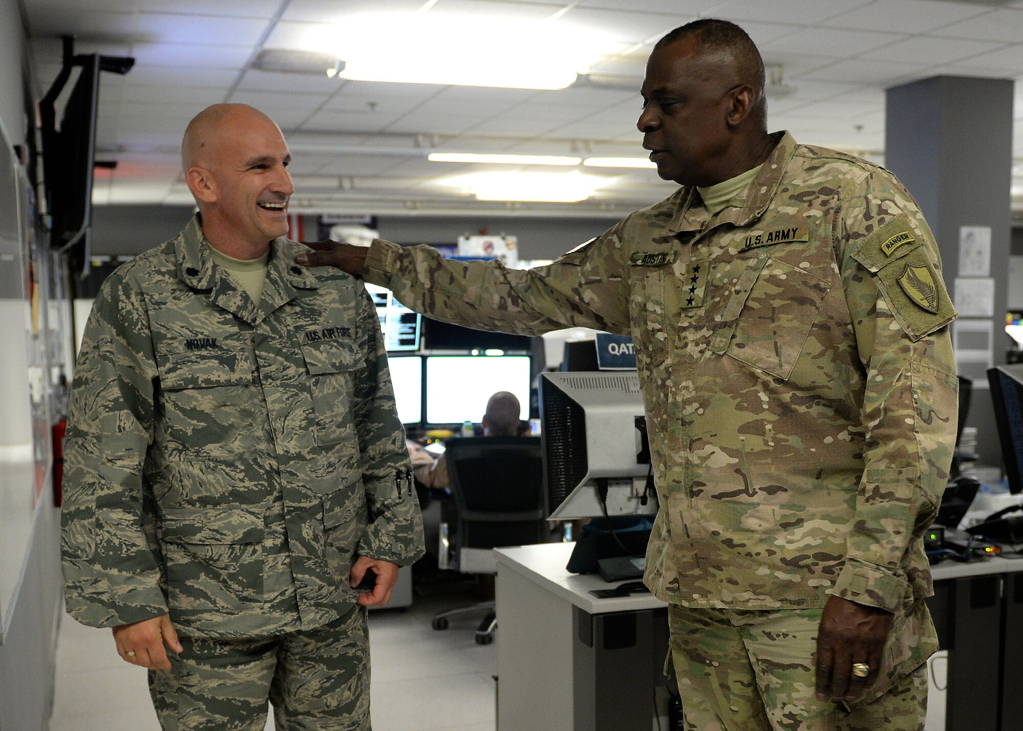 General Lloyd J. Austin III, commander of U.S. Central Command, greets U.S. Air Force Lt. Col. Robert Novak, deputy director of combat operations of the 609th Air Operations Center, during an orientation visit to the Combined Air and Space Operations Center, June 28, 2014, Al Udeid Air Base, Qatar. The CAOC provides the command and control of airpower throughout Iraq, Afghanistan and 18 other nations. (U.S. Air Force photo illustration by Staff Sgt. Shawn Nickel)