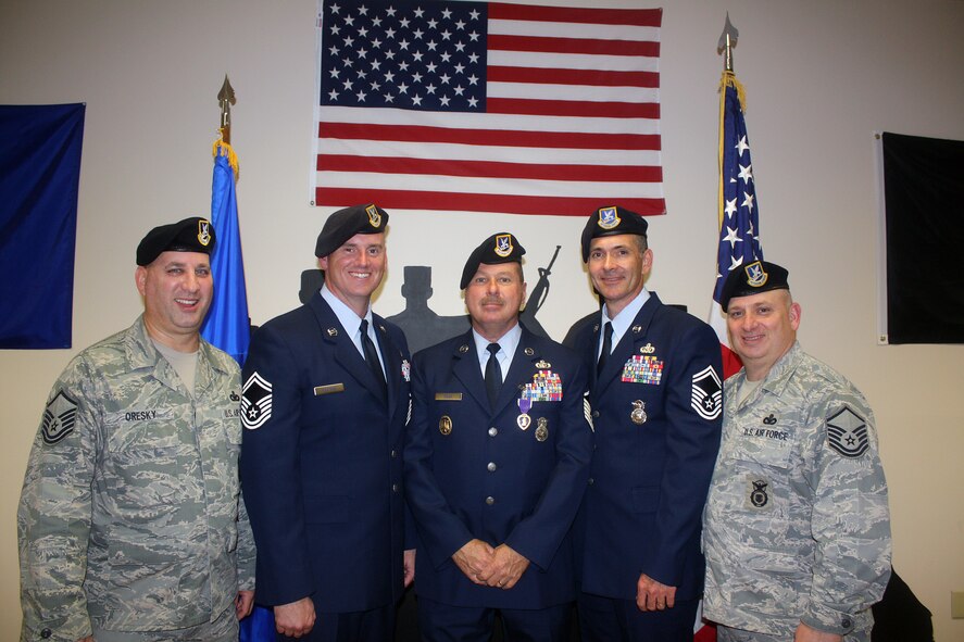 From left, Master Sgt. Kerry Oresky, Senior Master Sgt. Chad Martens, Master Sgt.
Edward Sileo, Senior Master Sgt. Wayne Radford, and Master Sgt. Charles
Williams, members of the 482nd Security Forces Squadron, Homestead Air Reserve base, Fla.,  pose for a group photo after Sileo was awarded the Purple Heart in a ceremony on Feb. 8. He was awarded the medal for injuries sustained Jan. 21, 2010 during a deployment in Kirkuk, Iraq. After his injury, Williams and Oresky assisted
Sileo by getting him needed medical attention. (U.S. Air Force photo/Senior Airman Jaimi Upthegrove)