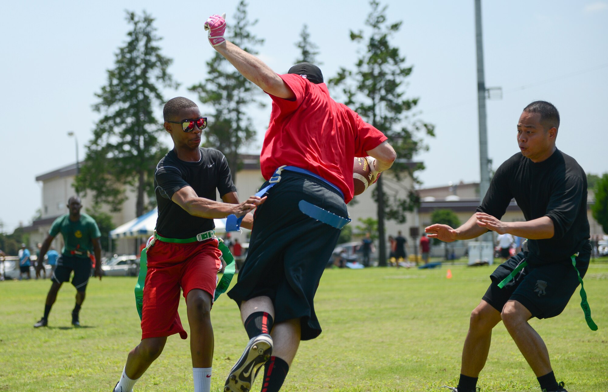 YOKOTA AIR BASE, Japan -- The quarterback with the 374th Civil Engineer Squadron flag football team receives a hiked football during Airman Appreciation Day at Yokota Air Base, Japan. During appreciation day squadrons on base compete through a variety of sports to decide an overall winner that receives a trophy and keeps it for a year. (U.S. Air Force photo by Staff Sgt. Cody H. Ramirez/Released)
