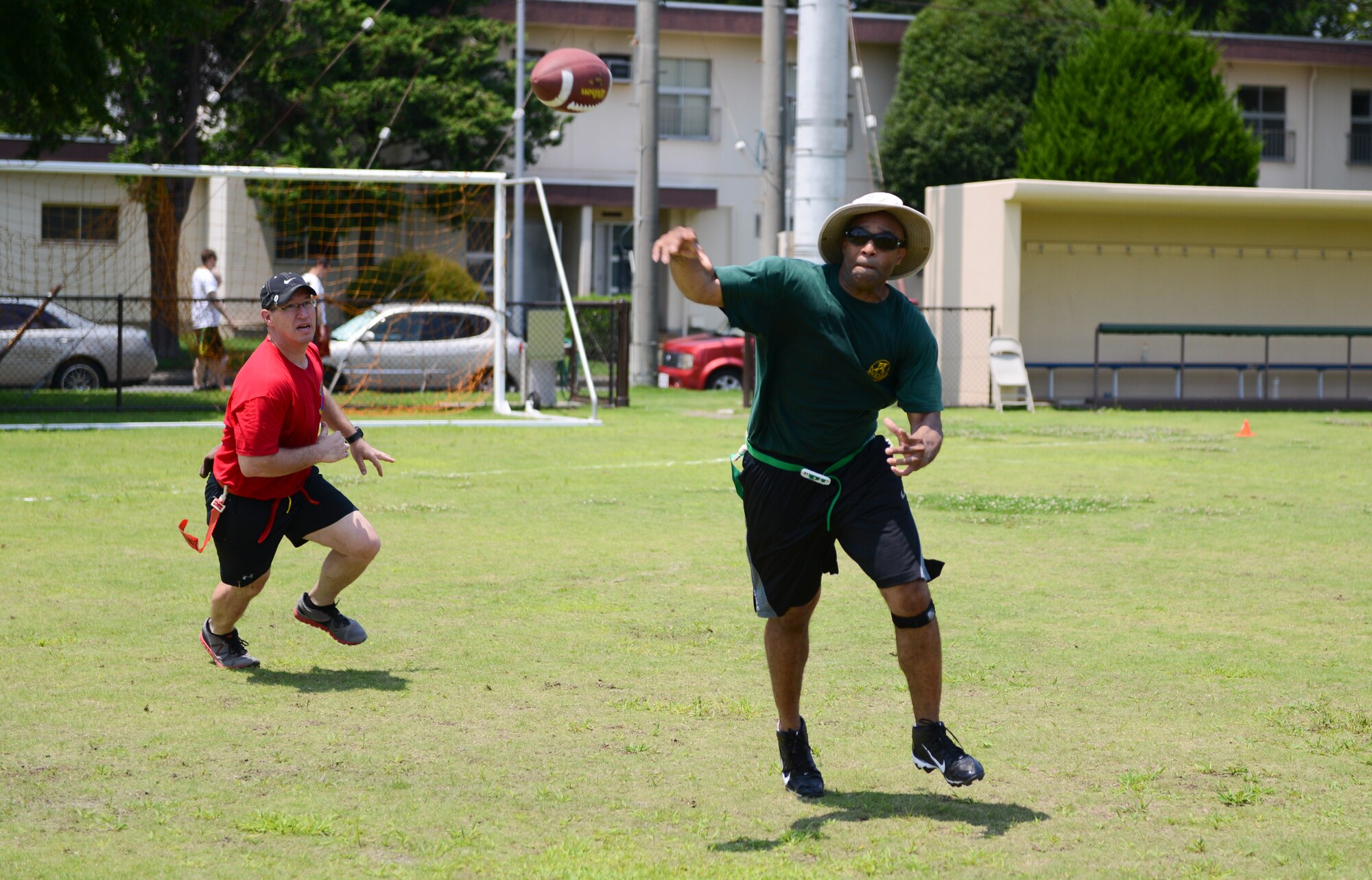 YOKOTA AIR BASE, Japan -- The quarterback with the 374th Civil Engineer Squadron flag football team throws a football to his receiver during Airman Appreciation Day at Yokota Air Base, Japan. During appreciation day squadrons on base compete through a variety of sports to decide an overall winner  that receives a trophy and keeps it for a year. (U.S. Air Force photo by Staff Sgt. Cody H. Ramirez/Released)
