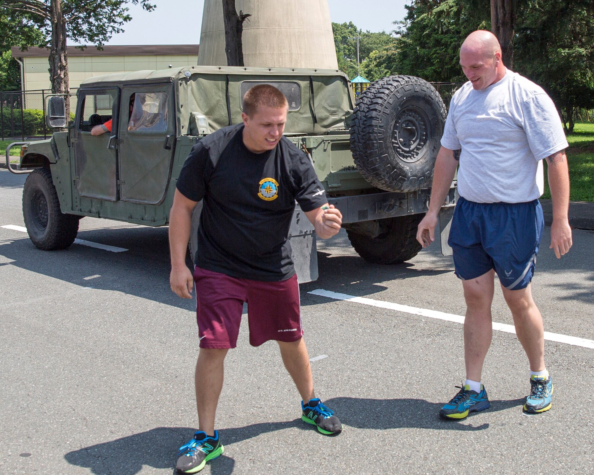 An Airman with the 374th Aircraft Maintenance Squadron finds his broken piece of sole after pushing a Humvee during Airman Appreciation Day at Yokota Air Base, Japan, July 25. 2014. Sports representatives from various units around Yokota organized teams to complete in sports such as flag football, sumo, volleyball and soccer. (U.S. Air Force photo by Osakabe Yasuo/Released)