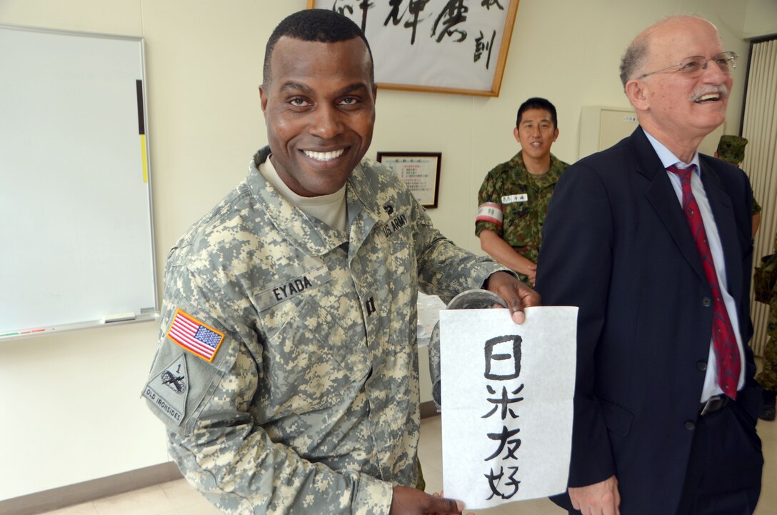 Capt. Jean Claude Eyada, Kanagawa Resident Office project engineer holds up his completed calligraphy project “U.S. -Japan friendship” which he practiced during the bilateral exchange program. 