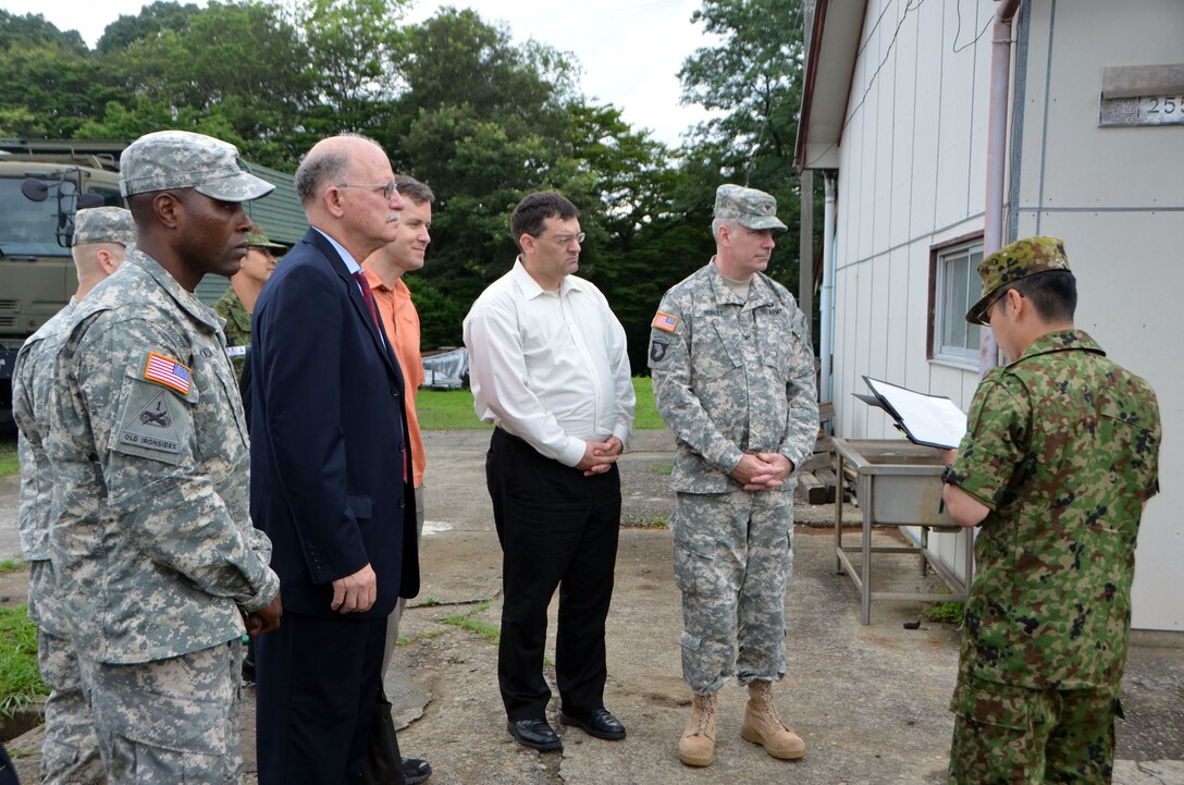 Officials from the U.S. Army Corps of Engineers, Japan Engineer District receive a briefing from a student of the Japan Ground Self Defense Force Engineer School at Camp Katsuta, July 9. From left: Capt. Jean Claude Eyada, Kanagawa Resident Office project engineer; Andrew Constantaras, chief of Engineering and Construction Division; Bryan Naquin, assistant district counsel; Daniel Reese (USARJ Interpreter); and Col. John Hurley, commander of the U.S. Army Corps of Engineers, Japan Engineer District. 