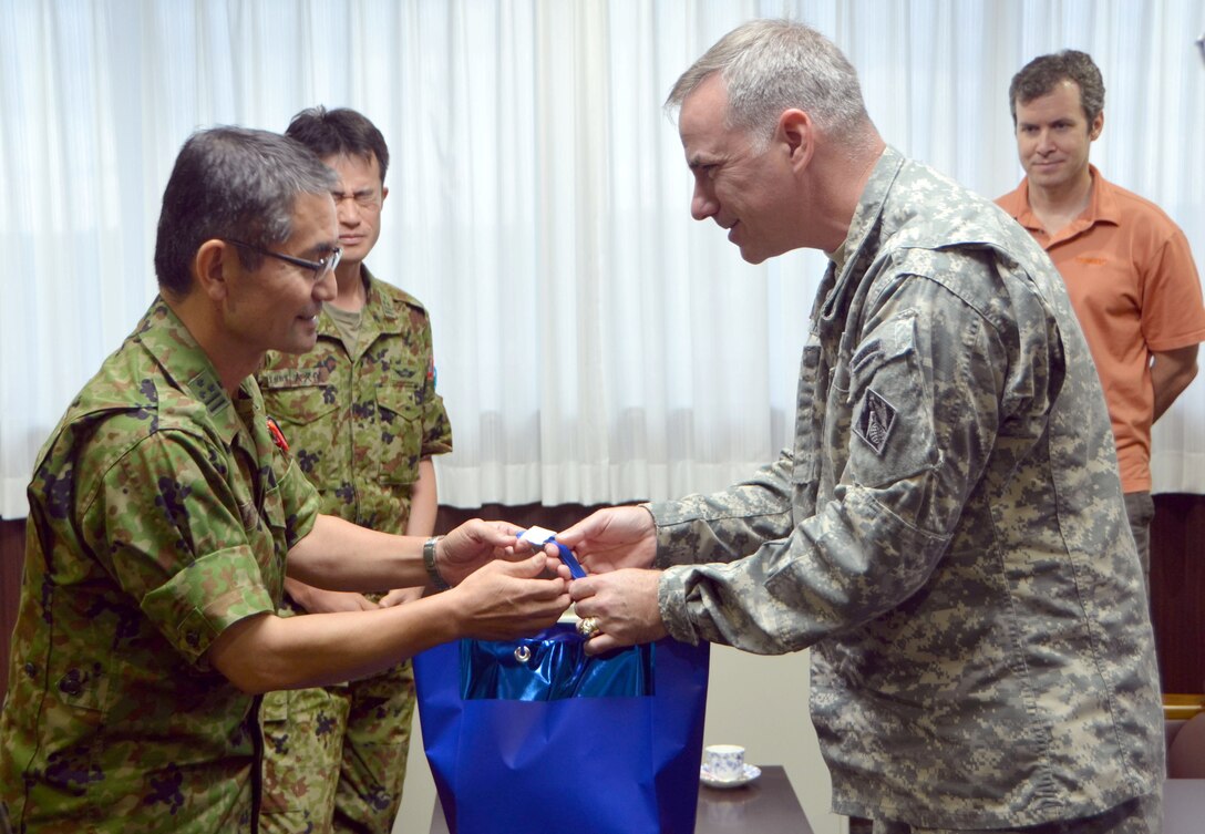 Col. Hirotomo Arai, vice commandant of the Ground Self Defense Force Engineer School and Col. John Hurley, U.S. Army Corps of Engineers, Japan Engineer District Commander exchange tokens of appreciation during the bilateral program held  July 9 at Camp Katsuta, Ibaraki Prefecture. 