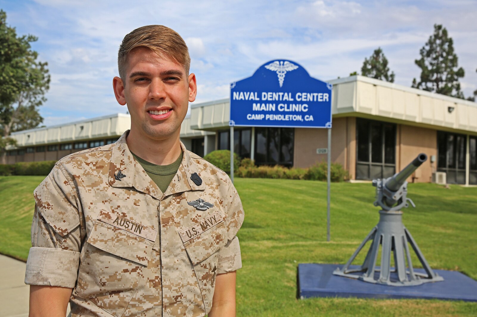 Petty Officer 3rd Class Andrew Austin, a dental technician with 1st Dental Battalion, 1st Marine Logistics Group, stands in front the 13 Area Dental Clinic aboard Camp Pendleton, Calif., July 23, 2014. Dental technicians provide much needed assistance to dentists by setting up and maintaining 
equipment, putting the patients at ease, preparing them for treatment and performing X-ray scans and administrative tasks. “As dental technicians, we need to take care of patients’ needs,” said Austin. “We work hand-in-hand with the dentists for eight hours a day to provide those needs and maintain combat readiness.” 