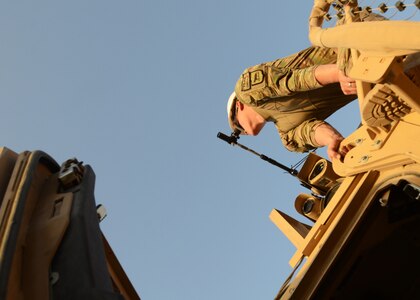 A Soldier with the 1742nd Transportation Company, South Dakota National Guard, bore sights his vehicle's weapon system while preparing for a convoy July 22, 2014, at Kandahar Airfield, Afghanistan. The 1742nd regularly escorts contracted semitrailers on convoys throughout southern Afghanistan as Regional Command-South closes outlying bases and draws down their forces. 