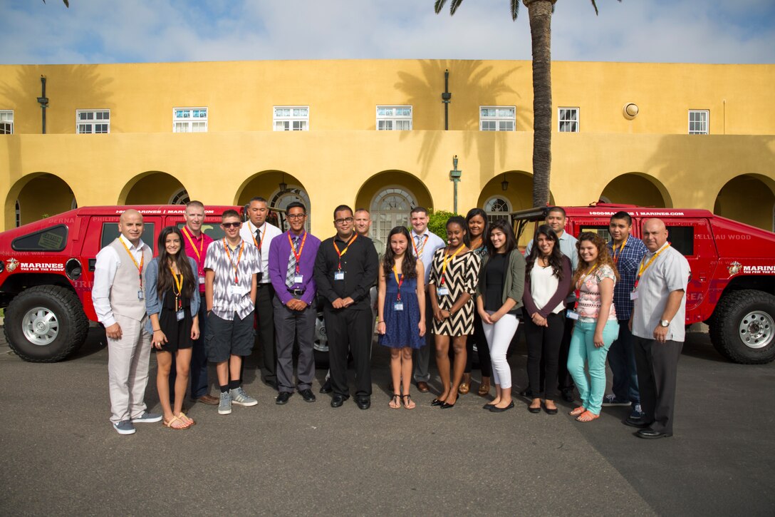 U.S. Marine Corps recruiters and their children pose for a group photo to mark the beginning of the 12th Marine Corps District's first annual Teen Summit aboard Marine Corps Recruit Depot San Diego, June 20, 2014.