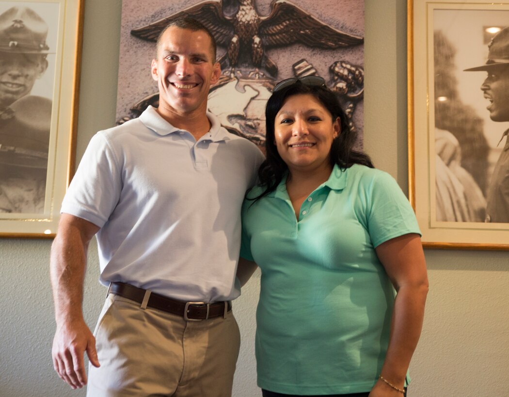 U.S. Marine Corps Lt. Col. Randal Walsh, left, and Maria RodriguezCallejas, right, smile for a photo during the 12th Marine Corps District's first annual Teen Summit aboard Marine Corps Recruit Depot San Diego, June 21, 2014.
