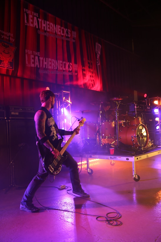 Stevie Benton plays a bass guitar while Mike Luce plays drums for Marines and Sailors during the For the Leathernecks III Comedy and Entertainment Tour at the Twin Rivers Theater at Marine Corps Air Station Cherry Point, July 25, 2014. Benton is the bass player and back-up vocalist, and Mike Luce is the drummer for the platinum-selling hard rock band Drowning Pool.


