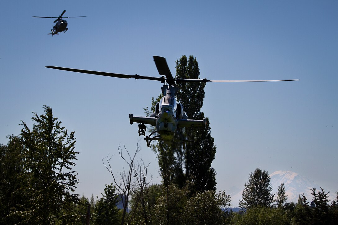 Pilots with Marine Light Attack Training Squadron 303 land their AH-1Z Super Cobra and UH-1Y Huey helicopters at the University of Washington during a Marine Week Seattle community relations event, July 28, 2014. Marine Week, held in Seattle for the first time from July 26 - August 3, is the Marine Corps' largest annual celebration of country, community and Corps. (U.S. Marine Corps photo by Sgt. Reece Lodder)