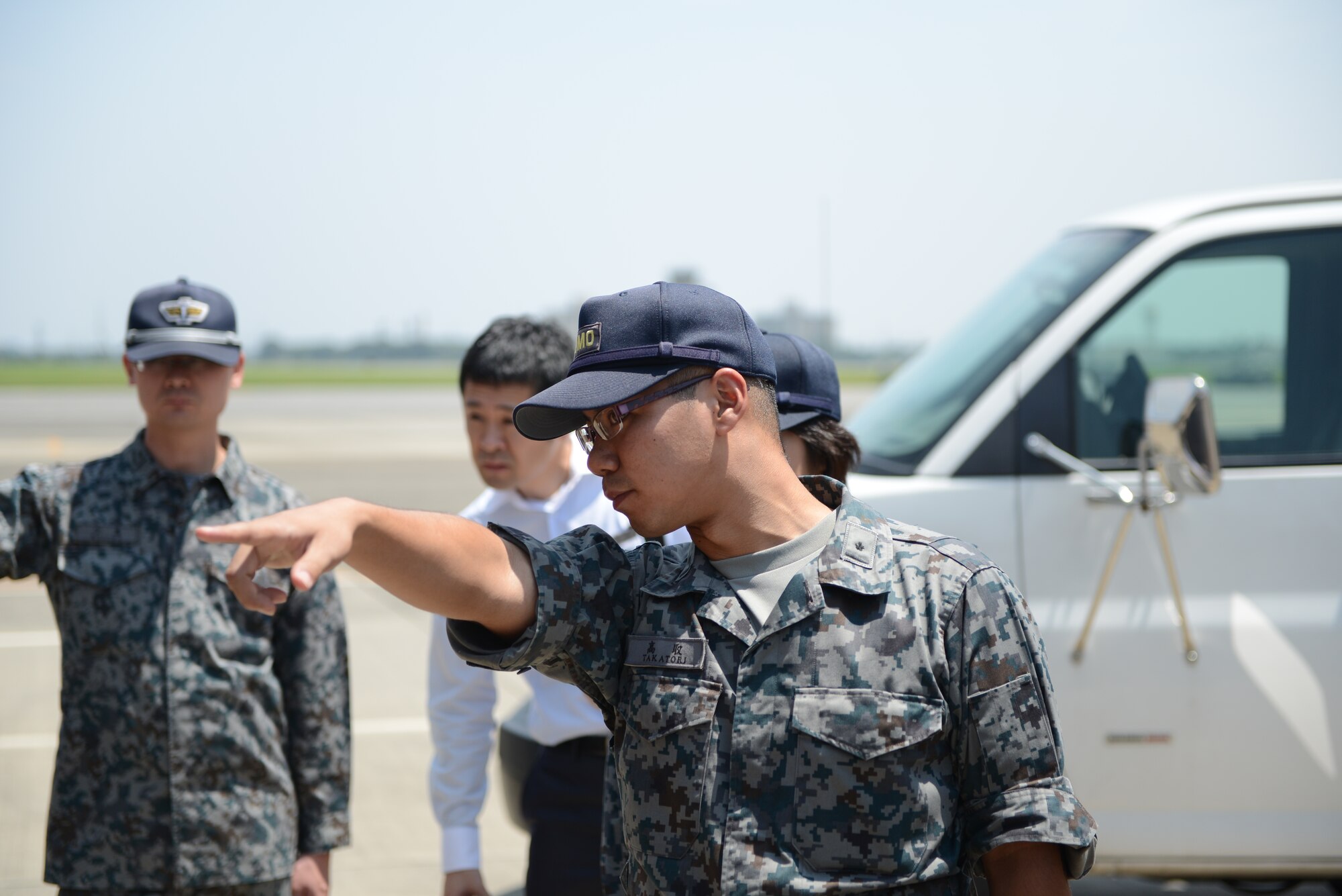 YOKOTA AIR BASE, Japan -- A Japan Air Self-Defense Forces maintenance officer asks a question to a member of the 374th Maintenance Squadron at Yokota Air Base, Japan, July 29, 2014. A group of JASDF maintenance officers came from Hamamatsu Air Base and visited Yokota to learn the similarities between Japanese and U.S. Air Force maintenance operations. (U.S. Air Force photo by Staff Sgt. Cody H. Ramirez/Released)