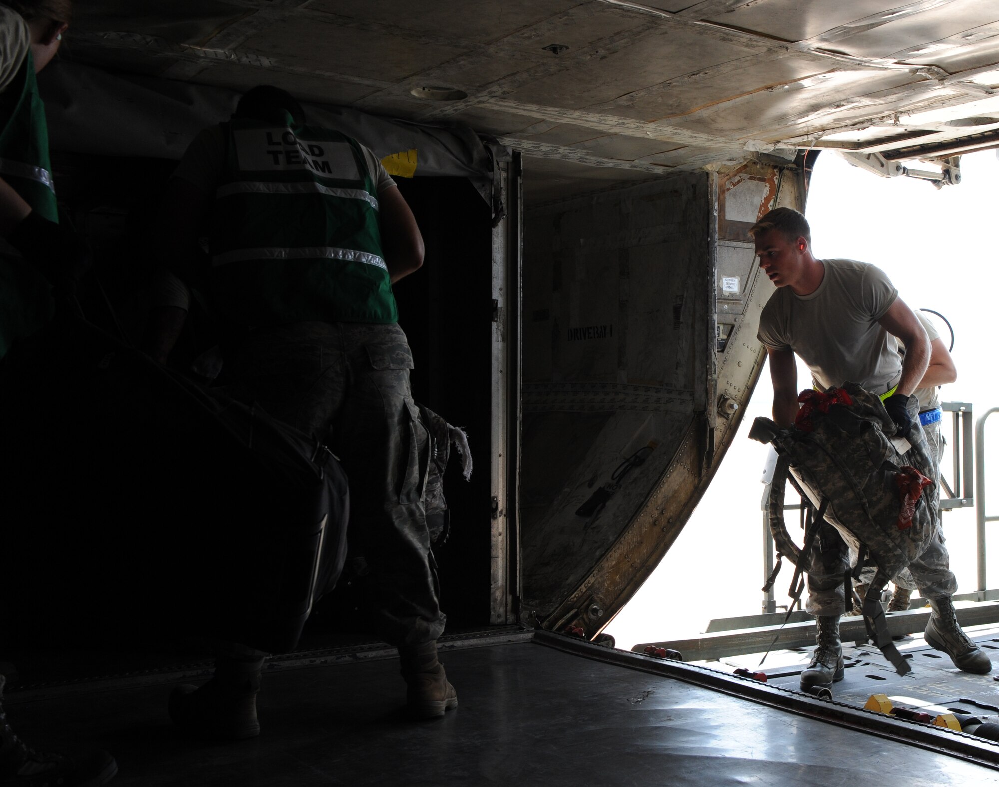 U.S. Air Force Airmen load bags onto a Boeing 747 passenger plane, July 29, 2014, at Dyess Air Force Base, Texas.  The bags traveled along with more than 350 Dyess personnel who recently deployed to Al Udeid Air Base, Qatar, in support of Operation Enduring Freedom. (U.S. Air Force photo by Airman 1st Class Alexander Guerrero/Released)