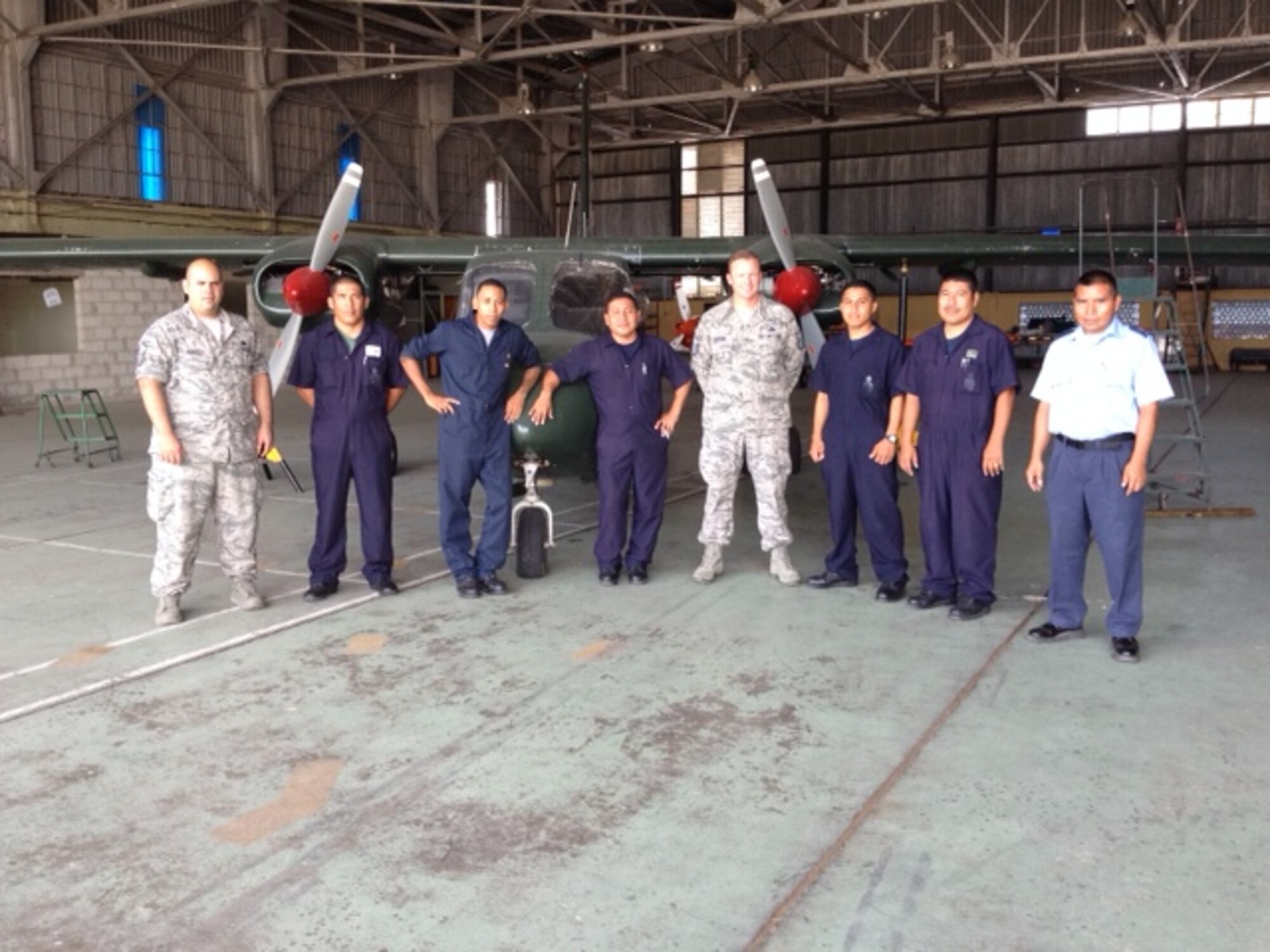 Master Sgts. Jeremy Jacobs  and Noel Mendoza, aircraft managers assigned to 12th Air Force (Air Forces Southern), stand for a photo with members of the Belize Defence Force Air Wing during a mobile training team event in Ladyville, Belize, June 30-July 11. (Courtesy Photo)
