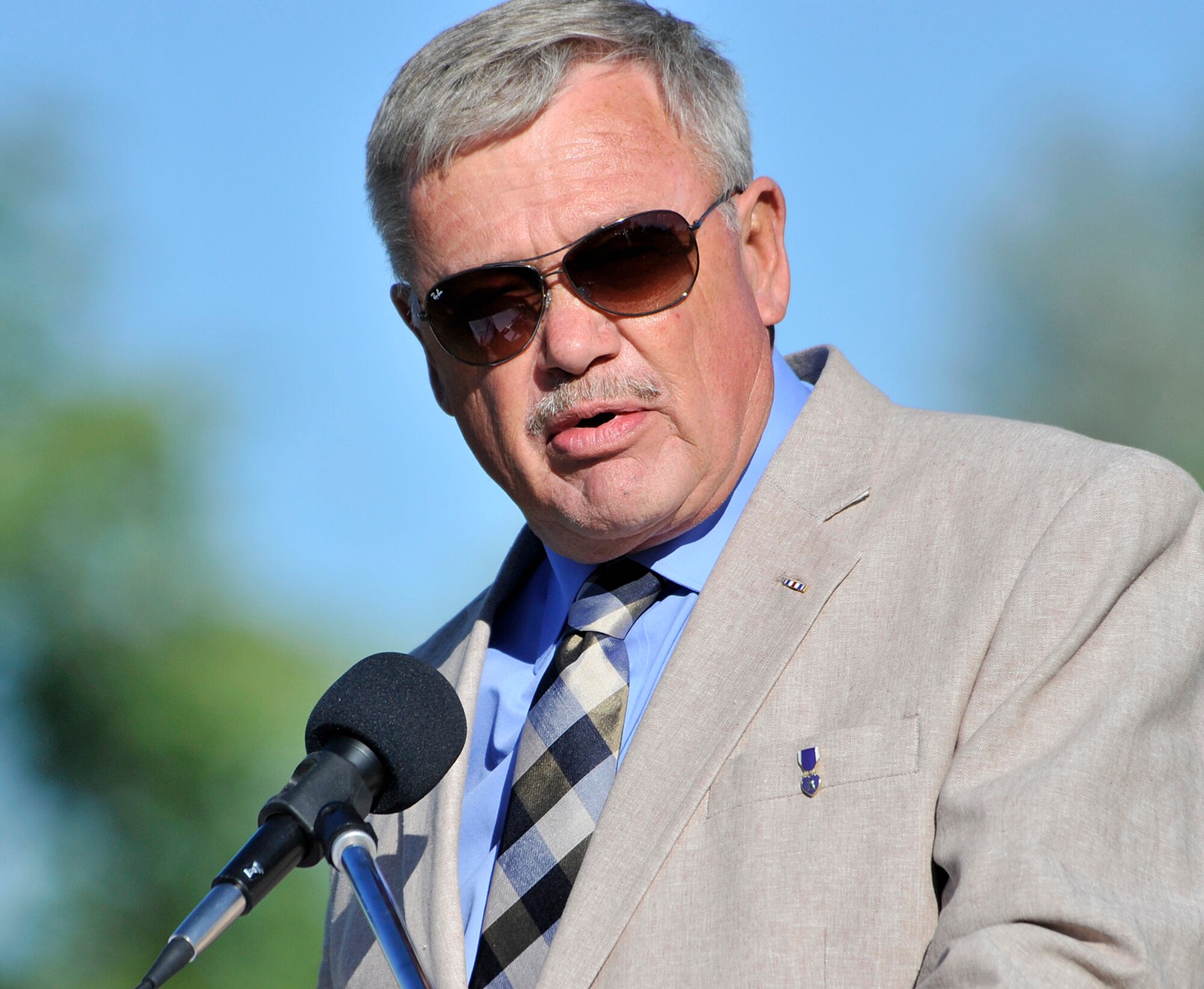 Bill Willing, chairman of Montana’s Veterans Affairs Board, delivers the keynote speech at the at The Wall That Heals opening ceremony and memorial service July 24 at Elk’s Riverside Park in Great Falls, Mont. Willing was a helicopter gunship pilot in Vietnam and flew 512 combat missions during the war. He spoke about the difficulty veterans have coping with the war and reintegrating into society, and the importance of the Vietnam Veterans Memorial for both individual and national healing. (U.S. Air Force photo/John Turner)