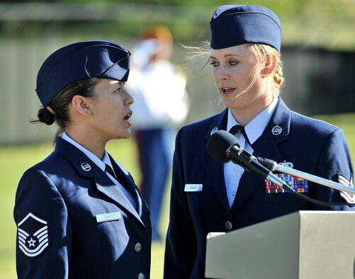 Master Sgt. Caressa Hewitt and Tech. Sgt. Tammy Wajer, both from the 120th Airlift Wing, Montana Air National Guard, sing the national anthem July 24 at The Wall That Heals opening ceremony and memorial service at Elk’s Riverside Park in Great Falls, Mont. (U.S. Air Force photo/John Turner)