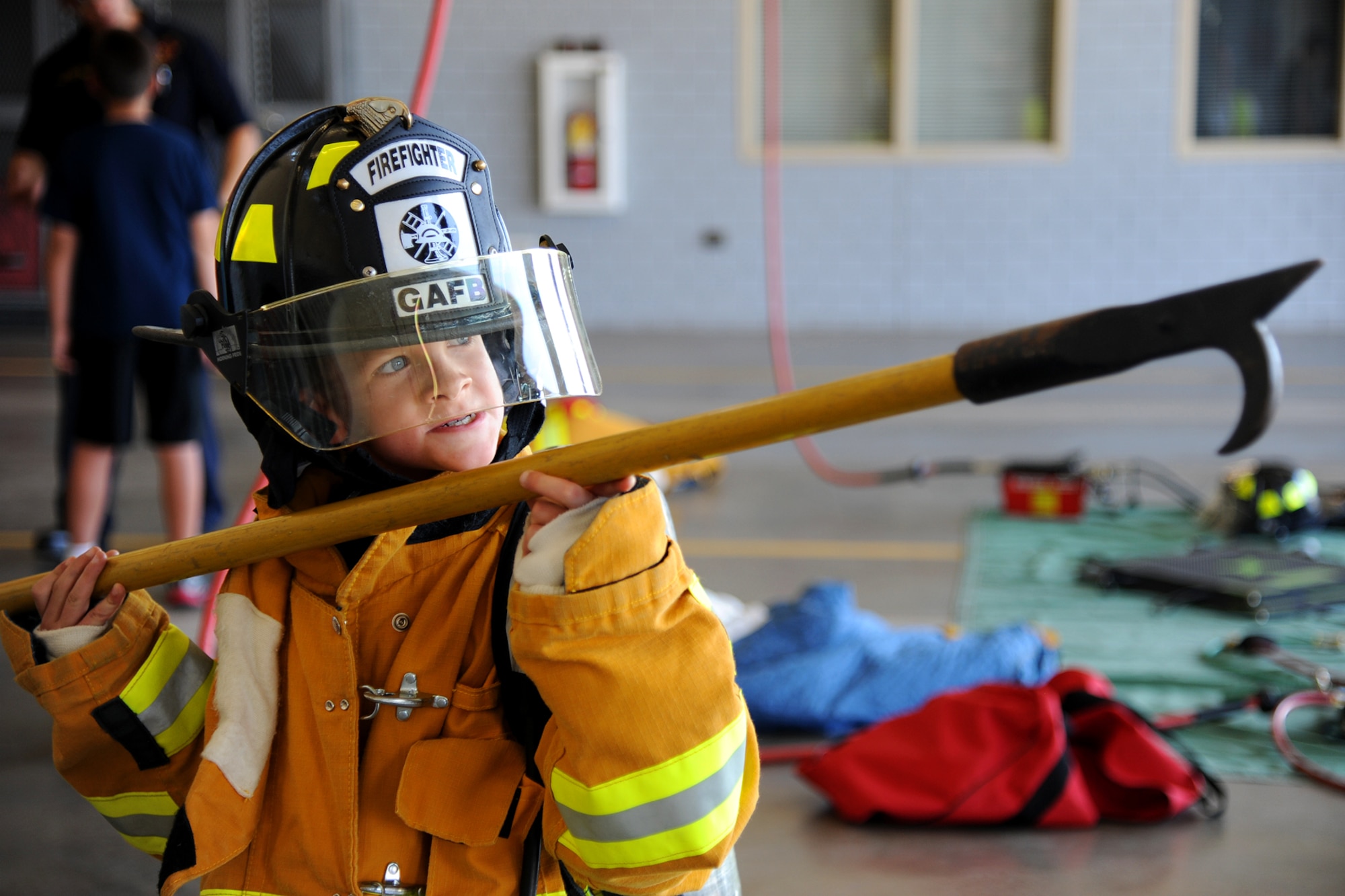 GOODFELLOW AIR FORCE BASE, Texas –Caleb Jackson, Junior Firefighter Camp participant, holds a pike pole at the fire department here July 23. Pike poles are used to pull items from intense heat and flames and to ventilate structures by breaking windows. (U.S. Air Force photo/ Airman 1st Class Devin Boyer)