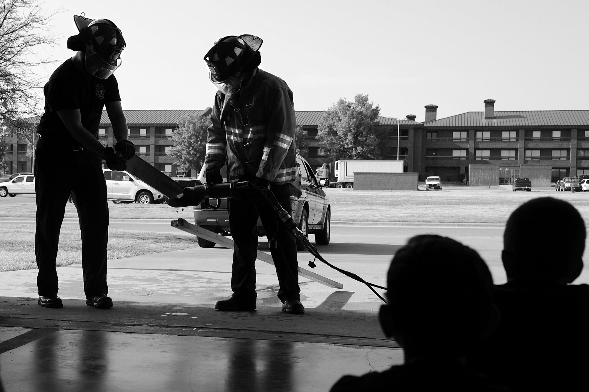 GOODFELLOW AIR FORCE BASE, Texas – Jay T. Teague and Teddy R. Spivey, 17th Civil Engineer Squadron Fire and Emergency Services firefighters, demonstrate how to use hydraulic cutters during the Junior Firefighter Camp at the fire department here July 23. Teague and Spivey used the cutters to sever a two-by-four in a matter of seconds. (U.S. Air Force photo/ Airman 1st Class Devin Boyer)