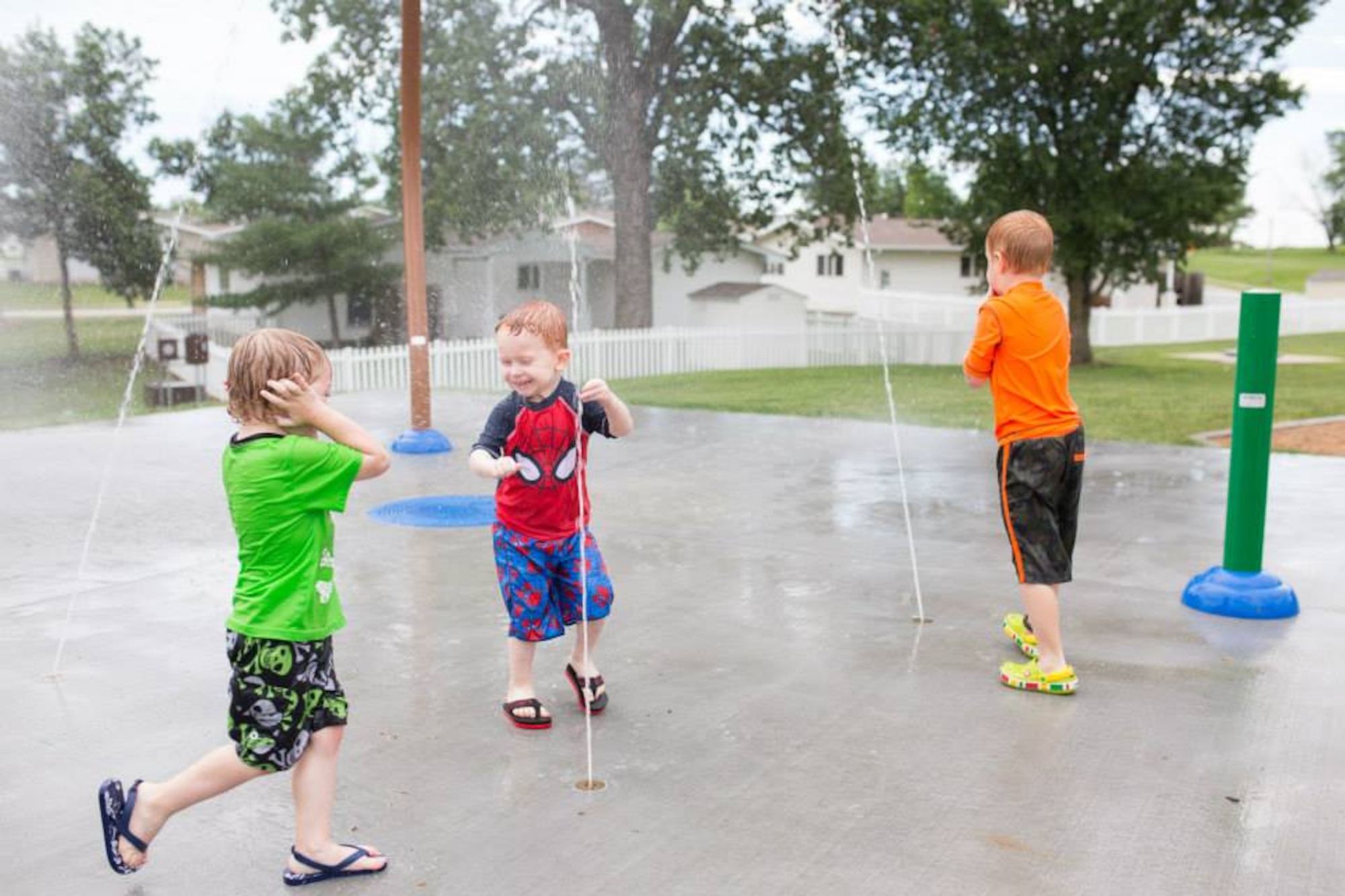 WHITEMAN AIR FORCE BASE, Mo. – Whiteman’s youngest residents enjoy cooling off in the neighborhood splash pad during a community celebration hosted by Balfour Beatty Communities July 1. The celebration marked the opening of the new neighborhood center. The 2,500 -quare foot complex houses a conference room and a multi-purpose entertainment room equipped with a flat screen television, chalkboard wall, table and chairs, and an attached kitchenette. (Photo courtesy of Balfour Beatty Communities)