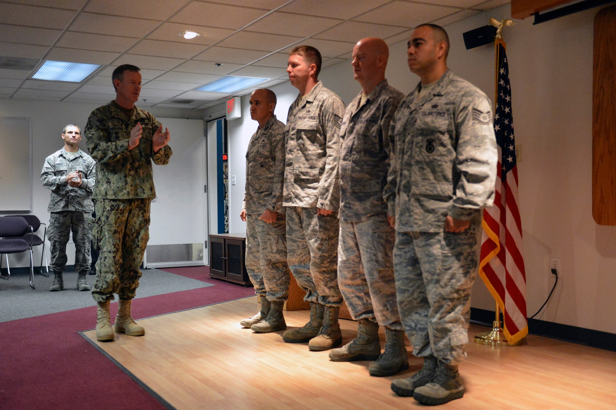 Admiral William McRaven (left), U.S. Special Operations Command commander, applauds four members of the 22nd Special Tactics Squadron after coining them July 23, 2014, during a visit to Joint Base Lewis-McChord, Wash. McRaven’s main message to the Airmen of the 22nd STS focused on preservation of force, family policies, and family resiliency. (U.S. Air Force photo/Staff Sgt. Russ Jackson)