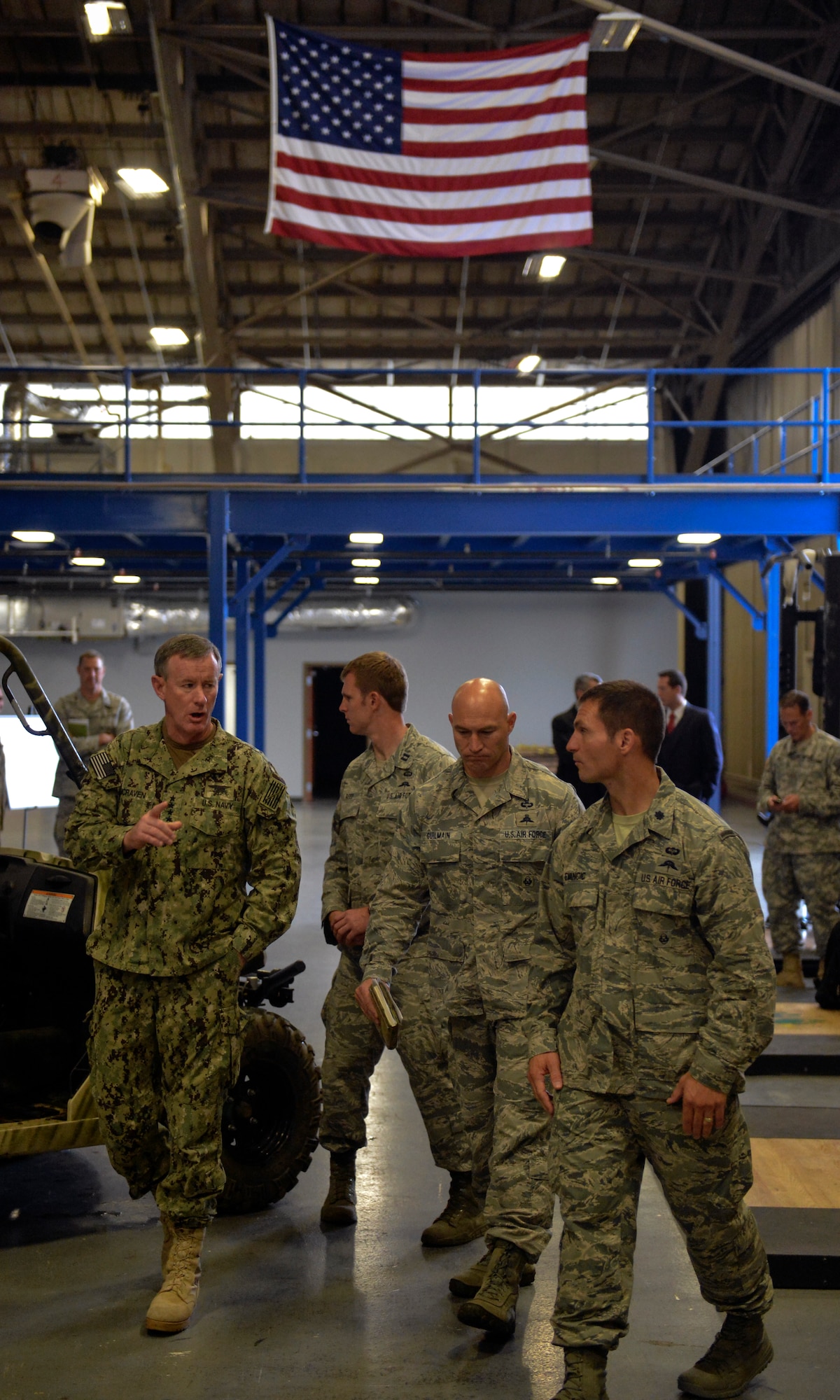 Admiral William McRaven (left), U.S. Special Operations Command commander, walks with Lt. Col. Michael Evancic (right), 22nd Special Tactics Squadron commander, and Chief Master Sgt. Jeff Guilmain (center), 22nd STS superintendent July 23, 2014, during a visit to Joint Base Lewis-McChord, Wash. McRaven toured the 22nd STS and spoke to them about preservation of the force and family while his wife, Mrs. Georgeann McRaven, met with spouses of the squadron’s Airmen. (U.S. Air Force photo/Staff Sgt. Russ Jackson)