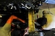 Senior Airman Timothy Davis and Airman 1st Class Cody Crawford, 5th Maintenance Squadron aerospace ground equipment apprentices, provide maintenance on a munitions hauling unit at Minot Air Force Base, N.D., July 23, 2014. AGE Airmen repair and maintain the ground equipment used to keep B-52H Stratofortresses prepared for flight. (U.S. Air Force photo/Senior Airman Brittany Y. Bateman)