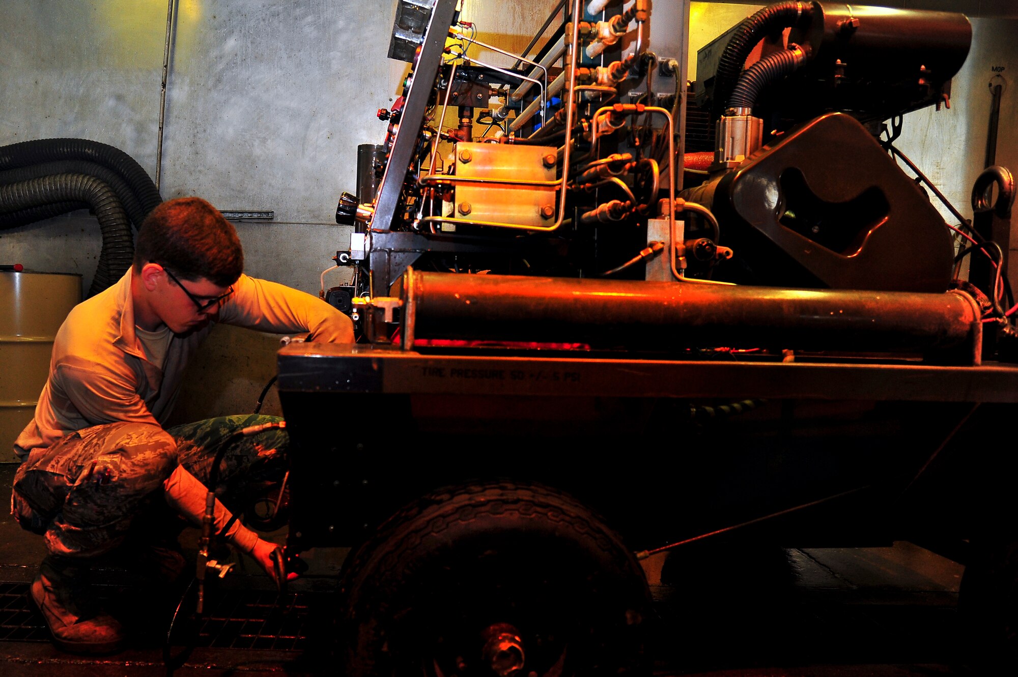 Airman 1st Class Jeffrey Nelson, 5th Maintenance Squadron aerospace ground equipment apprentice, re-panels a self-generating nitrogen cart on Minot Air Force Base, N.D., July 23, 2014. AGE Airmen maintain the equipment that supplies electricity, hydraulic pressure and air pressure to planes receiving maintenance on the flight line.  (U.S. Air Force photo/Senior Airman Brittany Y. Bateman)