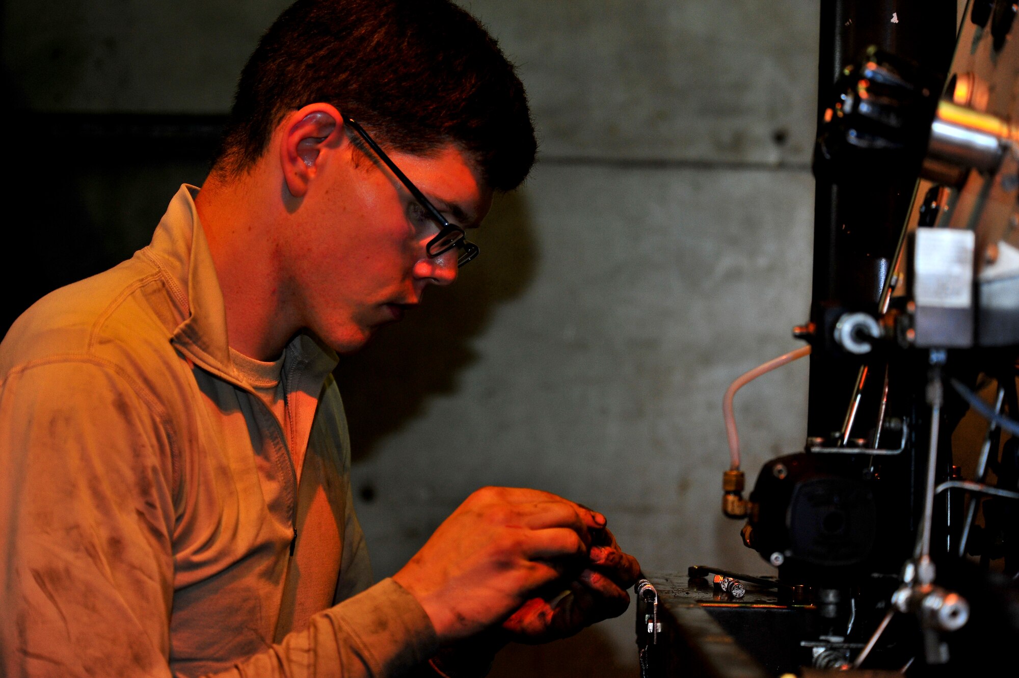 Airman 1st Class Jeffrey Nelson, 5th Maintenance Squadron aerospace ground equipment apprentice, re-panels a self-generating nitrogen cart on Minot Air Force Base, N.D., July 23, 2014. AGE Airmen repair and maintain the ground equipment used to keep B-52H Stratofortresses prepared for flight. (U.S. Air Force photo/Senior Airman Brittany Y. Bateman)
