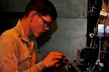 Airman 1st Class Jeffrey Nelson, 5th Maintenance Squadron aerospace ground equipment apprentice, re-panels a self-generating nitrogen cart on Minot Air Force Base, N.D., July 23, 2014. AGE Airmen repair and maintain the ground equipment used to keep B-52H Stratofortresses prepared for flight. (U.S. Air Force photo/Senior Airman Brittany Y. Bateman)