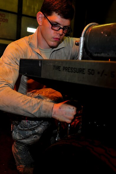Airman 1st Class Jeffrey Nelson, 5th Maintenance Squadron aerospace ground equipment apprentice, re-panels a self-generating nitrogen cart on Minot Air Force Base, N.D., July 23, 2014. AGE Airmen repair and maintain the ground equipment used to keep B-52H Stratofortresses prepared for flight. (U.S. Air Force photo/Senior Airman Brittany Y. Bateman)