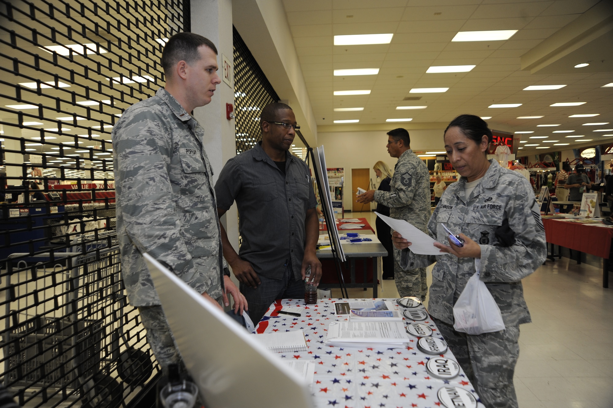 U.S. Air Force Master Sgt. Crispina Hutchinson(right), 12th Air Force, Air Forces Southern force protection, receives information about MiCare during Family Health and Fitness Fair at Davis-Monthan Air Force Base, Ariz., July 25, 2014. Over 100 people from around base visited the fair which was set up in the food court of the Base Exchange. (U.S. Air Force photo by Airman 1st Class Betty R. Chevalier/Released)