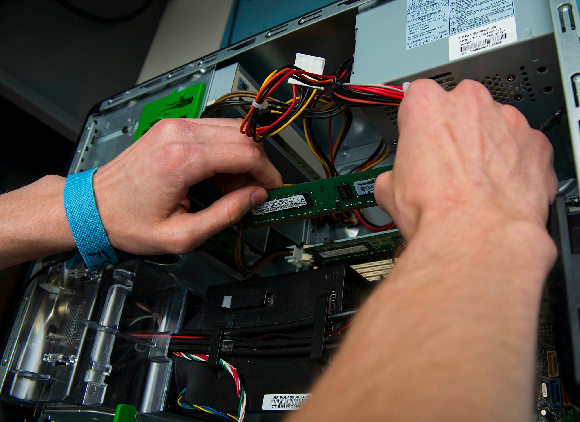A circuit board is removed from a computer in the 5th Communications Squadron headquarters on Minot Air Force Base, N.D., July 21, 2014. Airmen in the 5th CS maintain and support base communication systems through a variety of equipment including computers, radios and blackberries. (U.S. Air Force photo/Senior Airman Stephanie Morris)