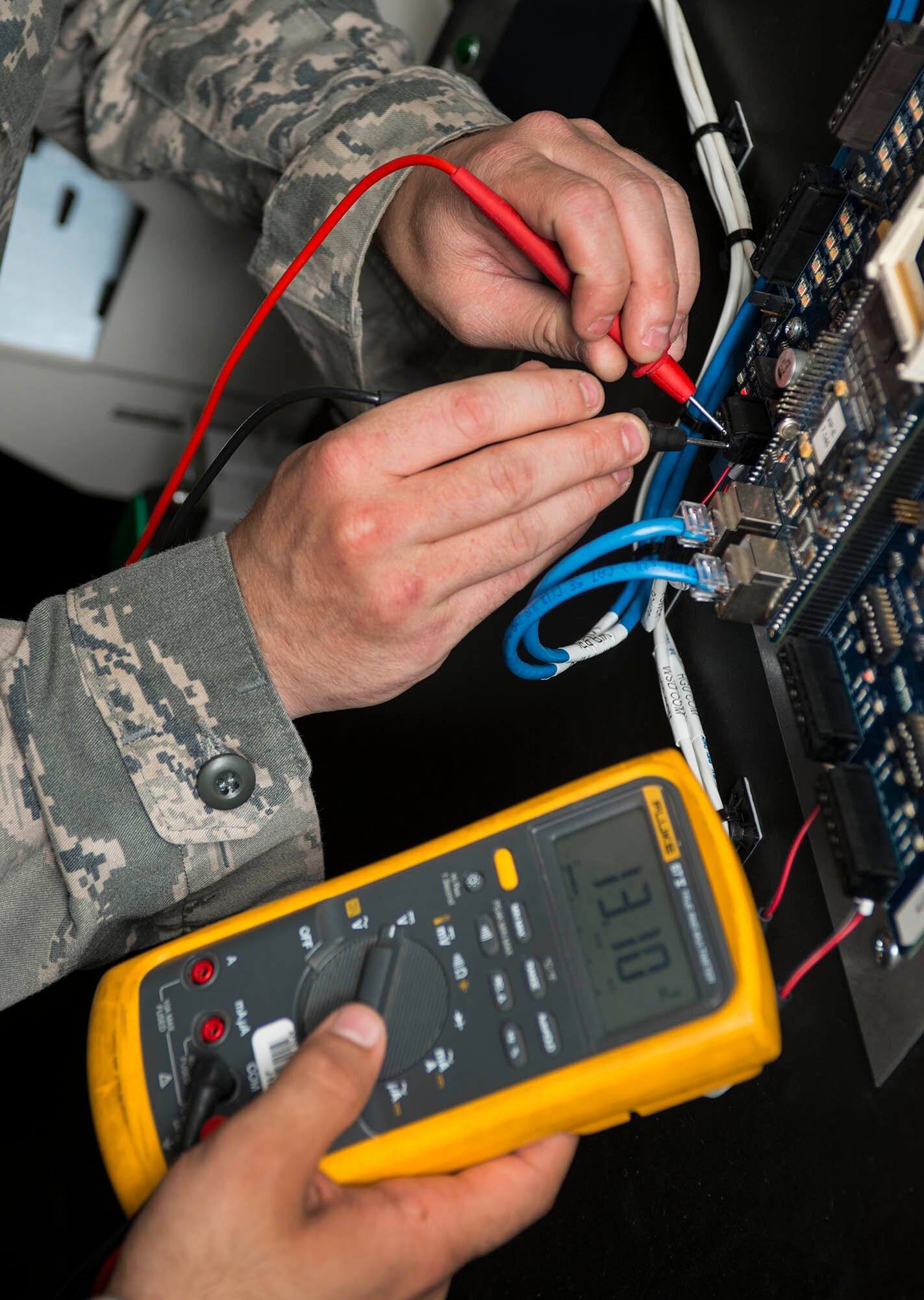 A panel is checked for a charge in the 5th Communications Squadron headquarters on Minot Air Force Base, N.D., July 21, 2014. Airmen in the 5th CS take a variety of precautionary measures while maintaining and repairing mission essential communication equipment to ensure the safety of all involved. (U.S. Air Force photo/Senior Airman Stephanie Morris)