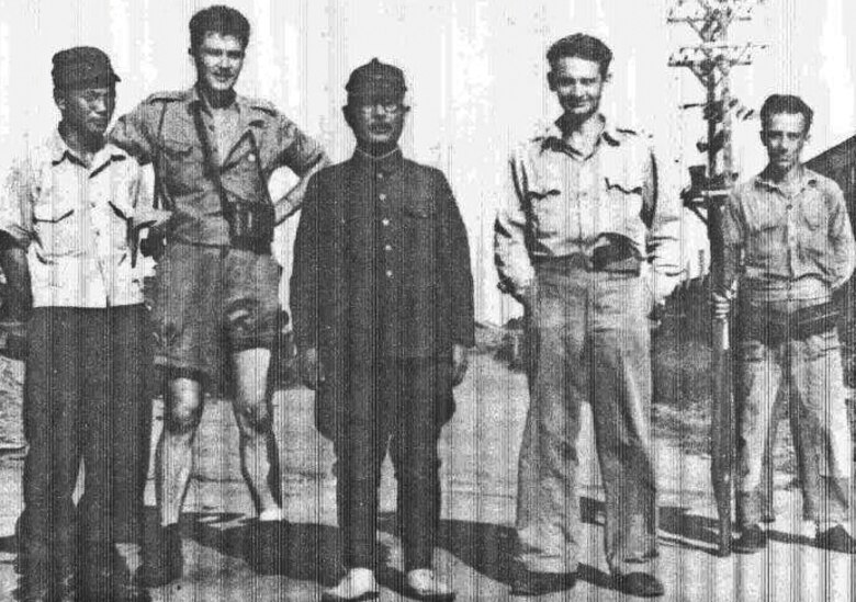 James J. Bollich (far right) with a rifle guarding the Japanese commander of their prisoner of war camp at the wars end. (Courtesy Photo)