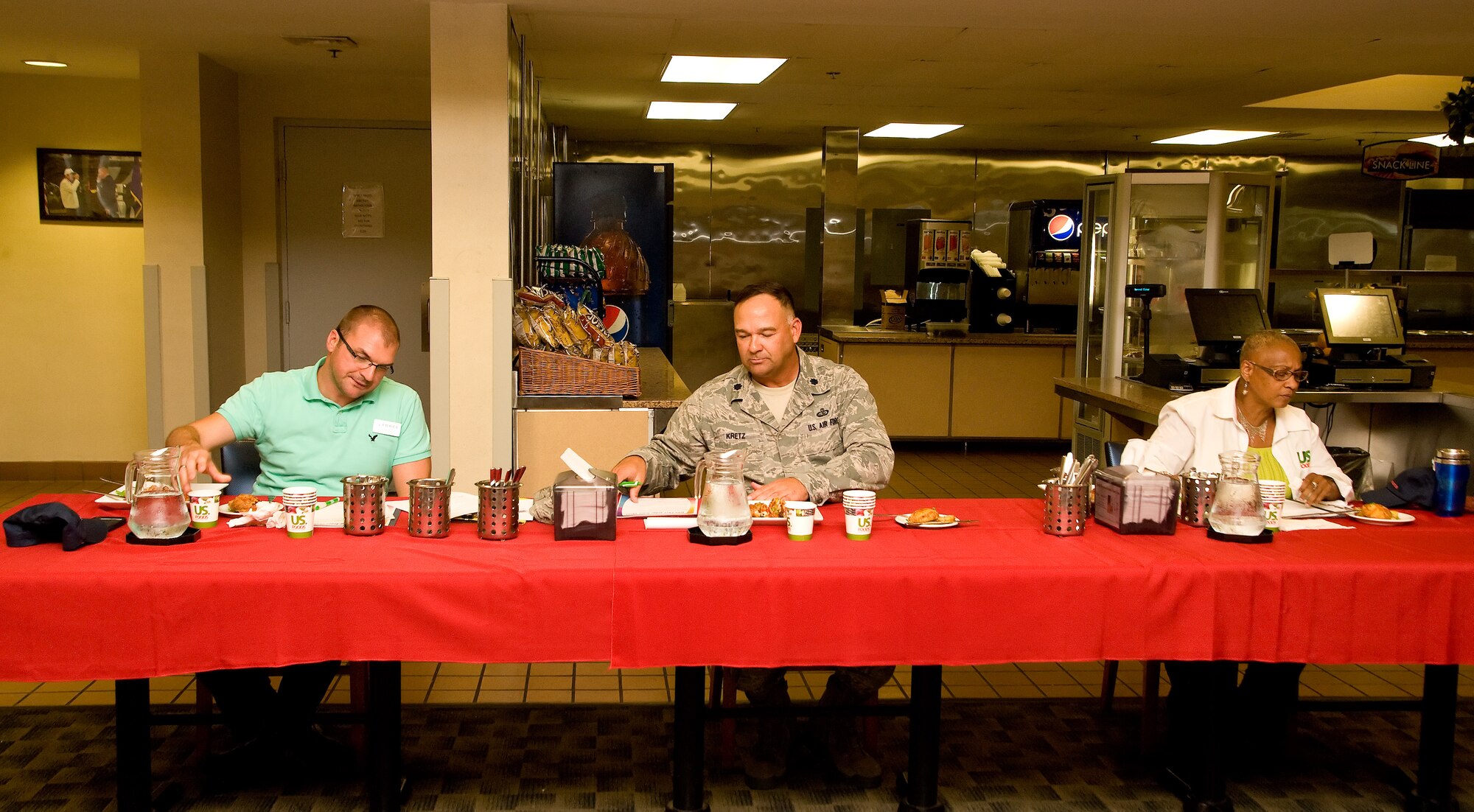 Jeffrey Moore, left, 436th Force Support Squadron bowling center manager; Lt. Col. David Kretz, center, Air Force Mortuary Affairs Operations deputy commander; and Sheila Harris, US Foods military account manager, sit at the judges table scoring the appetizer entries July 24, 2014, at the Patterson Dining Facility on Dover Air Force Base, Del. Judges also scored entrée and dessert items presented to them during the Dover Iron Chef competition. (U.S. Air Force photo/Roland Balik)