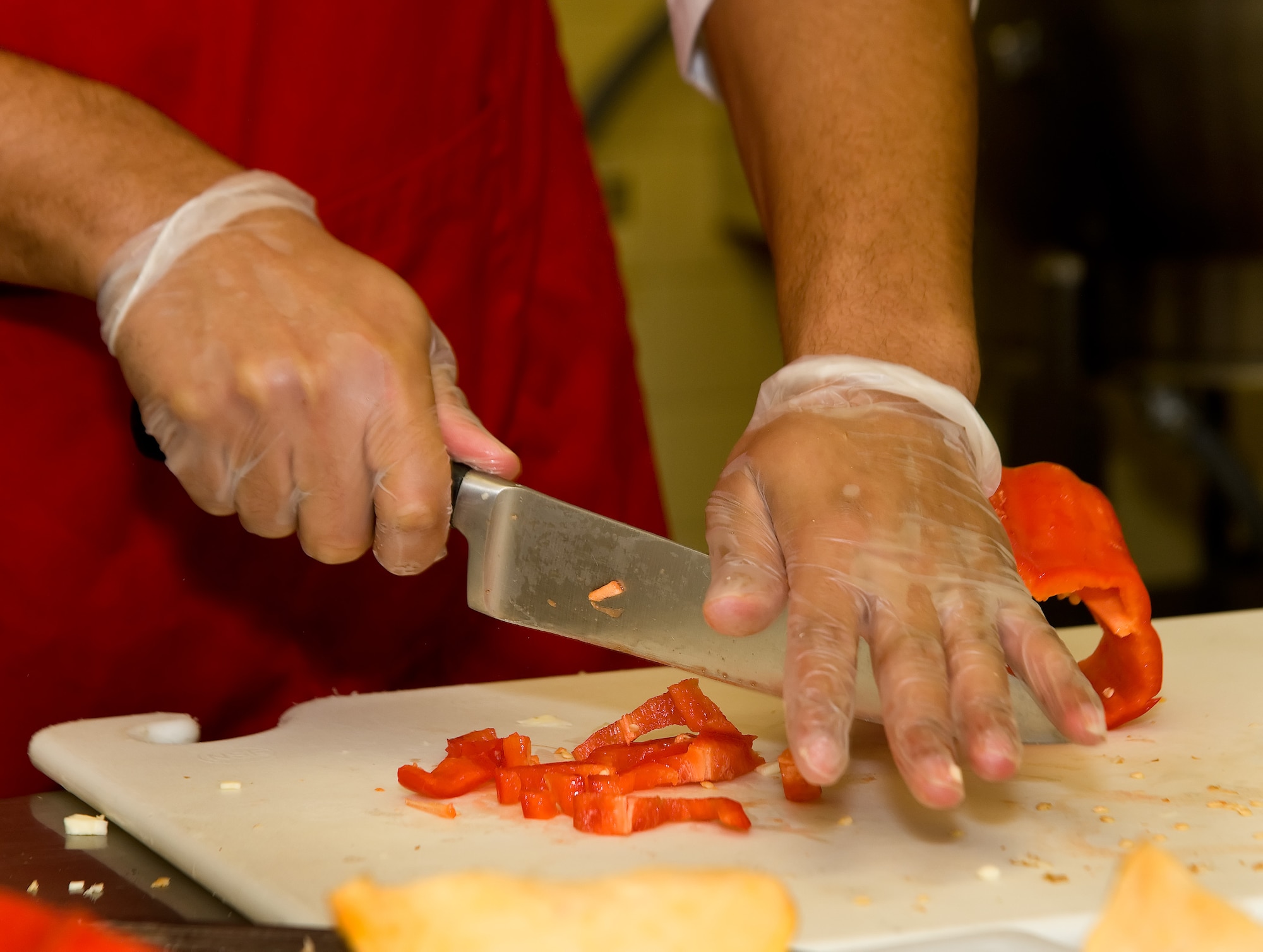 Staff Sgt. Brian Sosa, 436th Force Support Squadron dices a red pepper July 24, 2014, at the Patterson Dining Facility on Dover Air Force Base, Del. Sosa headed the 436th Force Support Squadron team of four entered in the Dover Iron Chef competition and challenged by a team from Air Force Mortuary Affairs Operations. (U.S. Air Force photo/Roland Balik)