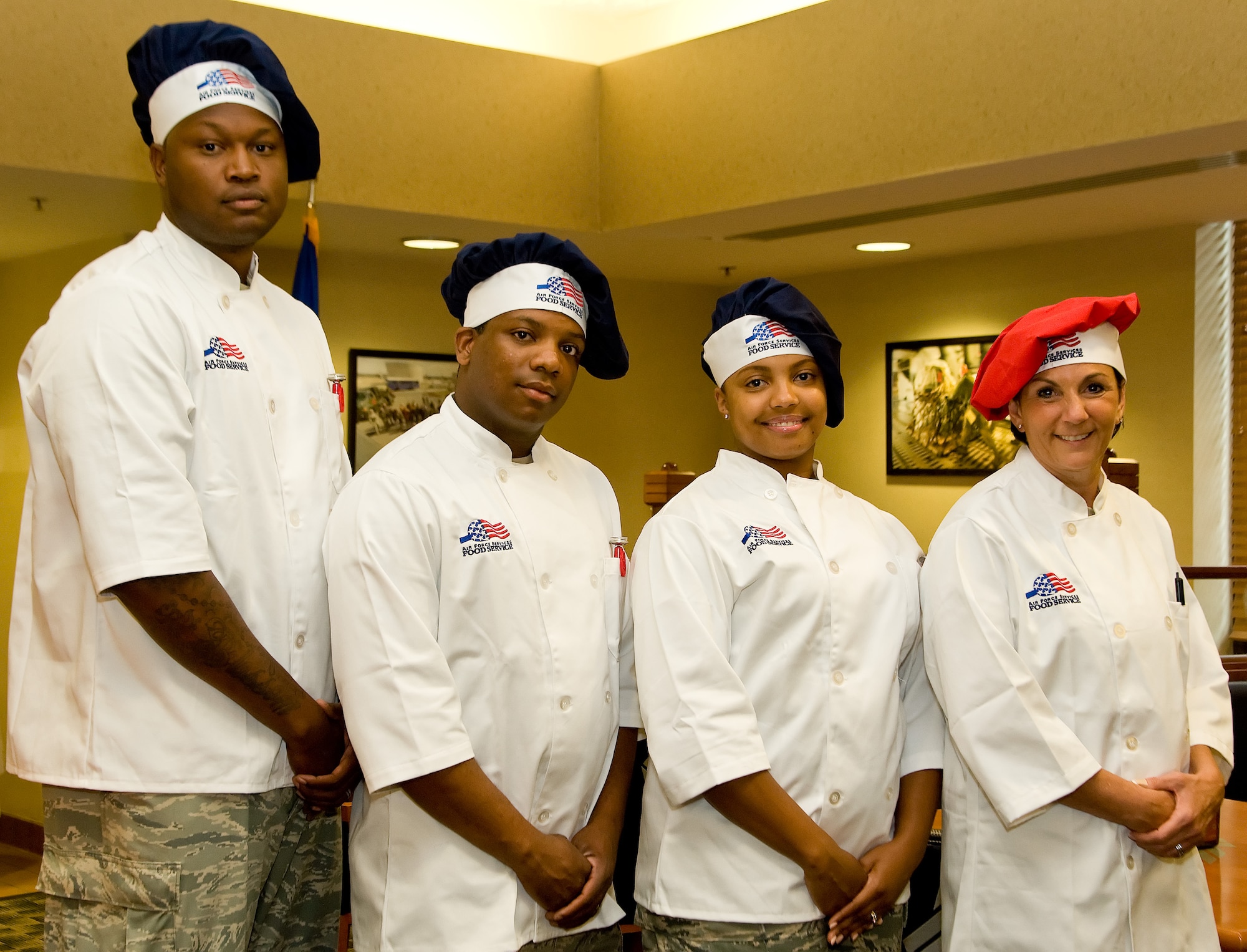 The winning team of the Dover Iron Chef competition representing Air Force Mortuary Affairs Operations, pose for a photo July 24, 2014, at the Patterson Dining Facility on Dover Air Force Base, Del. Pictured left to right, Staff Sgt. Andre Hunter, 375th Force Support Squadron, Scott Air Force Base, Ill.; Staff Sgt. Earl Simmons, 315th Force Support Squadron, Joint Base Charleston, S.C.; Senior Airman Jaqe Wesley, 512th Memorial Affairs Squadron, Dover AFB, Del.; and Maj. Andrea Pitruzzella, 914th Airlift Wing Public Affairs, Niagara Falls Air Reserve Station, N.Y.; out-cooked a team from the 436th FSS, Dover AFB.  (U.S. Air Force photo/Roland Balik)