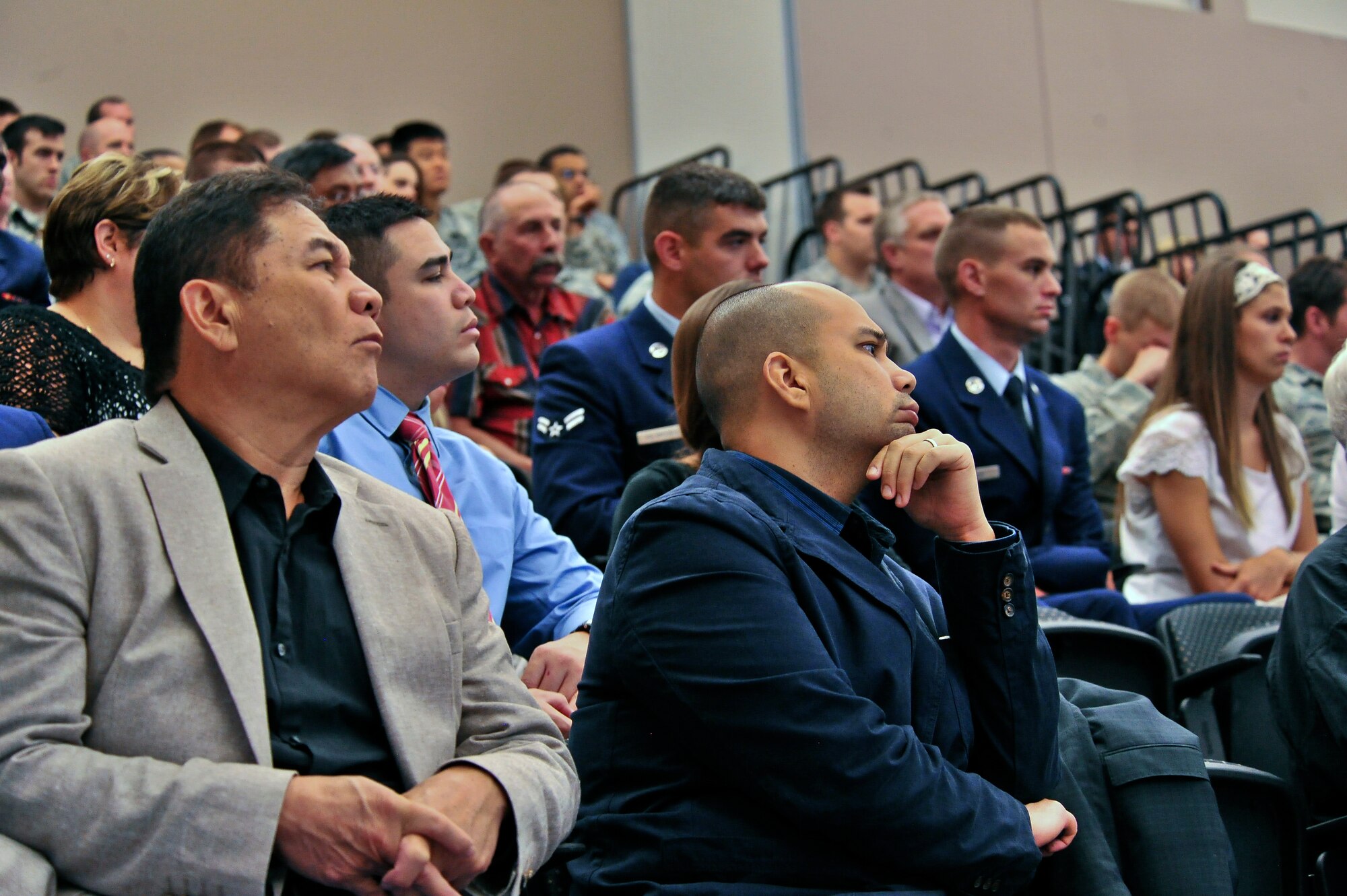 Audience members made up of Survival, Evasion, Resistance and Escape graduates and their families along with Fairchild Airmen listen as James J. Bollich talks about his time as a prisoner of war during World War II in the 336th training Group auditorium at Fairchild Air Force Base, Washington, June 26, 2014. Bollich was a prisoner of war during World War II and a survivor of the Bataan Death March. (U.S. Air Force photo by Staff Sgt. Alexandre Montes/Released)