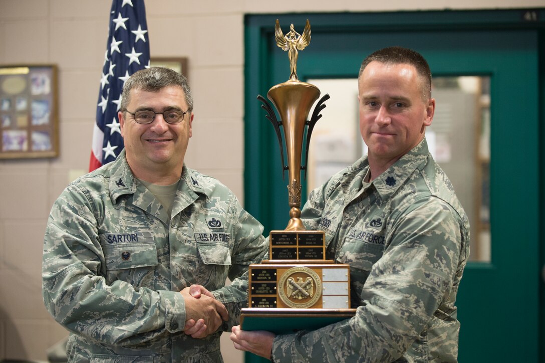 Col. Peter Sartori (left) presents the Deneke Award to Lt. Col. Keith Hodsden of the 158th Civil Engineering Squadron on June 6, 2014 at the Vermont Air National Guard. This marks the third time the VTANG Civil Engineering Squadron has been granted this award, it is given each year to the Air National Guard unit that shows the most outstanding accomplishments and achievements.  (U.S. Air National Guard photo by Senior Airman Jon Alderman)