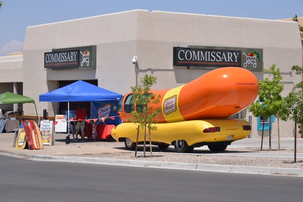 The Oscar Meyer Weiner Mobile stopped at the Kirtalnd Commissary July 25 to promote it's beef bologna and other products. Patrons visiting the promotion received free hot dogs and other items. (Photo by Todd Berenger) 
