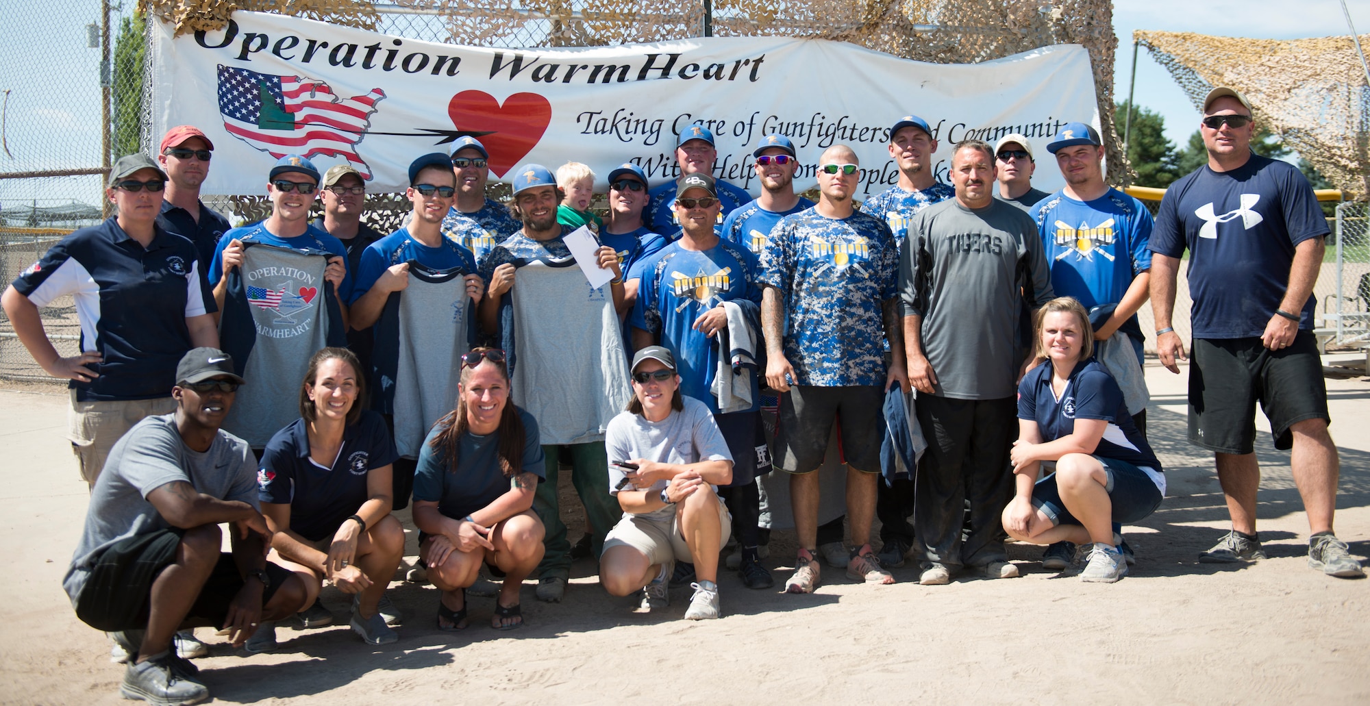 The team “Reloaded” poses with the first sergeants after winning the championship during the Operation Warmheart softball tournament July 26, 2014, at Mountain Home Air Force Base, Idaho. Teams from across Idaho participated in the event lasting 72 hours. (U.S. Air Force photo by Airman 1st Class Malissa Lott/RELEASED)