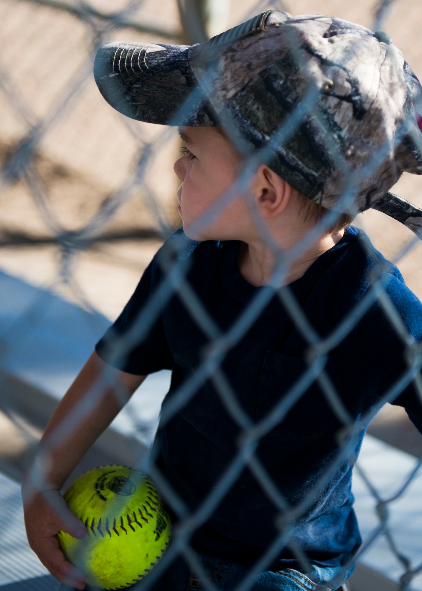 A little boy watches the Operation Warmheart softball tournament July 26, 2014, at Mountain Home Air Force Base, Idaho. The tournament lasted for three days straight to raise money for Gunfighters and their families. (U.S. Air Force photo by Airman 1st Class Malissa Lott/RELEASED)