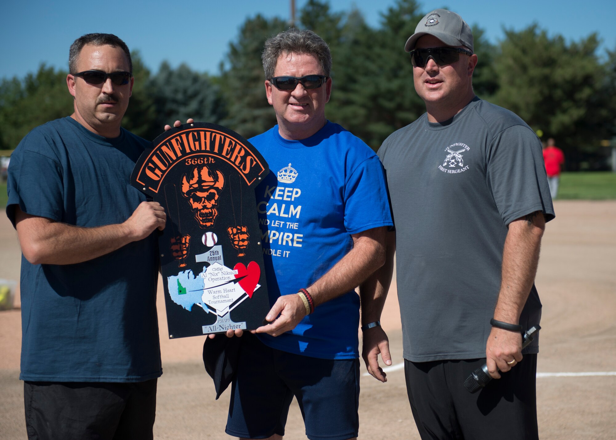 Allen Niksich, 366th Force Support Squadron community readiness specialist, receives a plaque at the 25th annual Operation Warmheart softball tournament July 25, 2014, at Mountain Home Air Force Base, Idaho. Niksich began the tournament 25 years ago to help raise money for Gunfighters and their families. (U.S. Air Force photo by Airman 1st Class Malissa Lott/RELEASED)