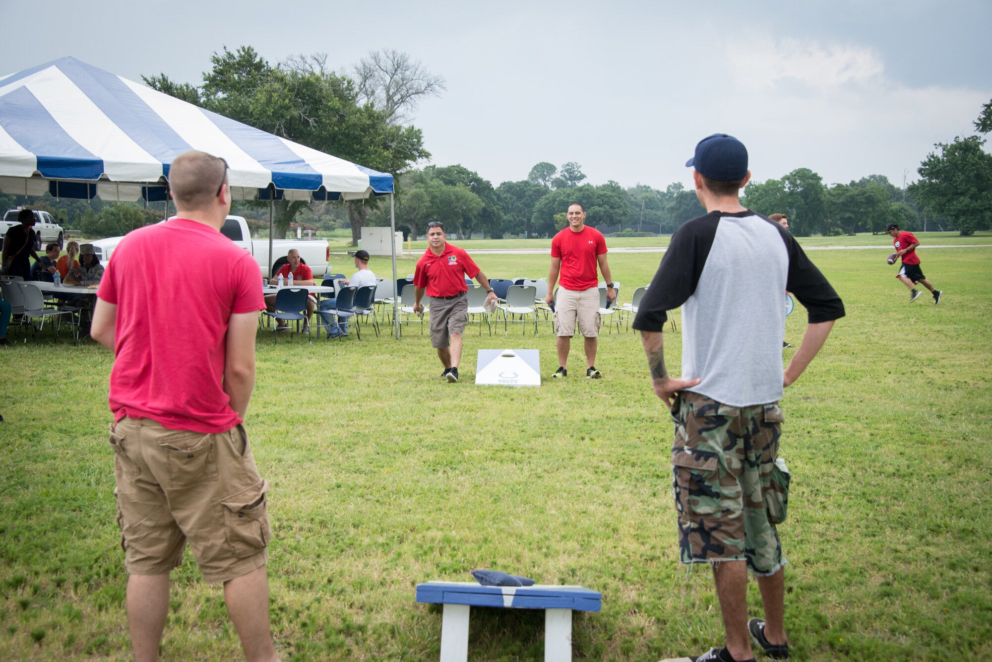 Chief Master Sgt. Eli Santos, 81st Training Support Squadron, tosses a bean bag while playing a game of Corn Hole during a block party July 25, 2014, next to the Shaw House, Keesler Air Force Base, Miss.  The event, hosted by the Airman's Council and the Dorm Council, was open to all ranks and benefitted the 81st Training Wing Airmen recognition fund. (U.S. Air Force photo by Marie Floyd)