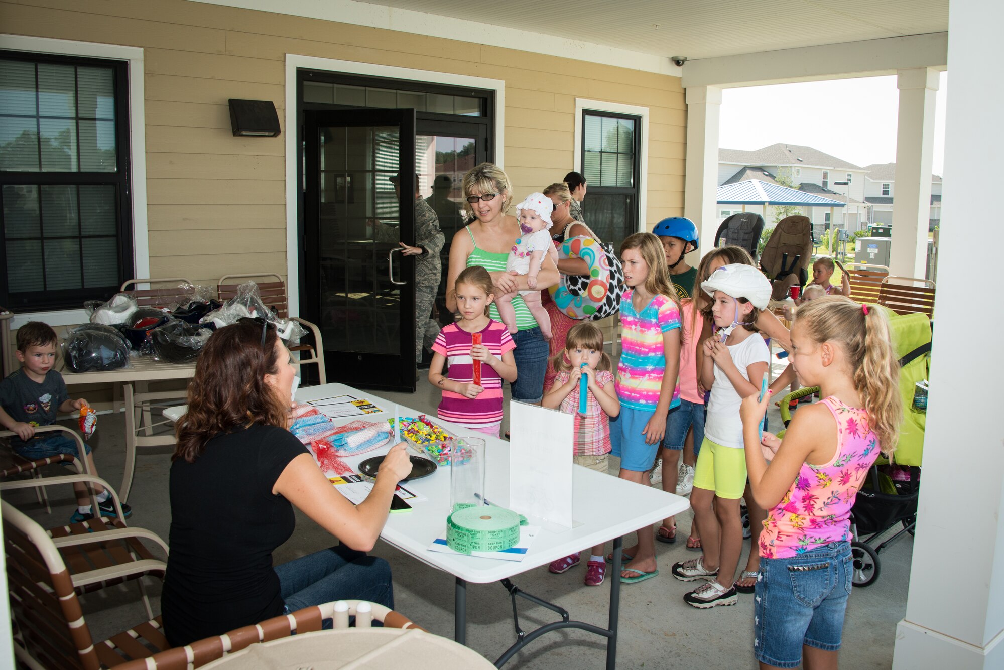 Brittany Theriot, Forest City Community Services, raffles off new helmets and bikes for Keesler families during the 81st SFS Bike Rodeo July 25, 2014, at the Forest City Community Center, Keesler Air Force Base, Miss.  The event, hosted by 81st SFS and Forest City Community Services, was held for Keesler families to perform and promote safety checks for bikes and car seats.  (U.S. Air Force photo by Marie Floyd)